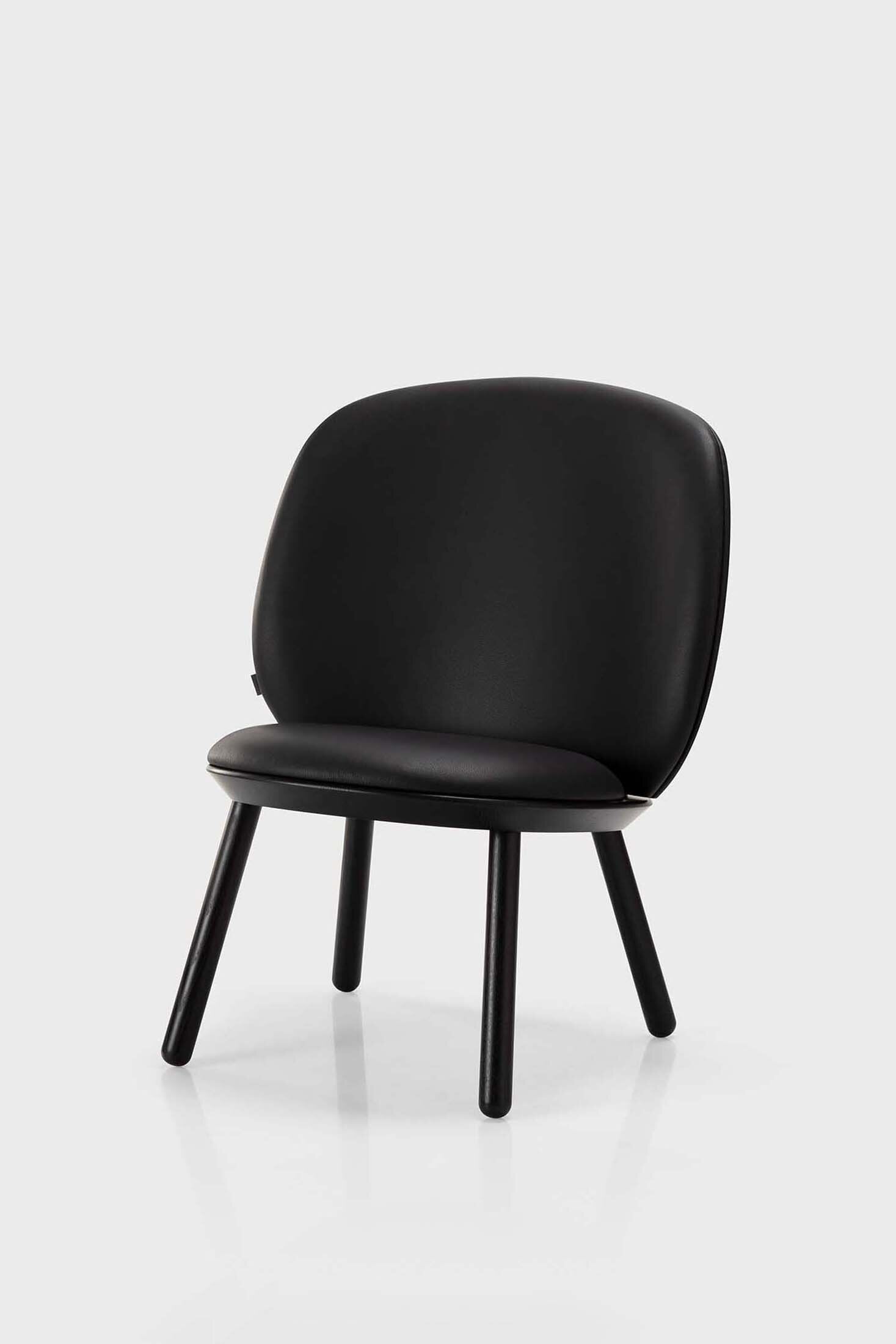 Naïve Low Chair in Black Solid Ash featuring a leather strap backrest, showcasing its elegant design and sturdy construction.