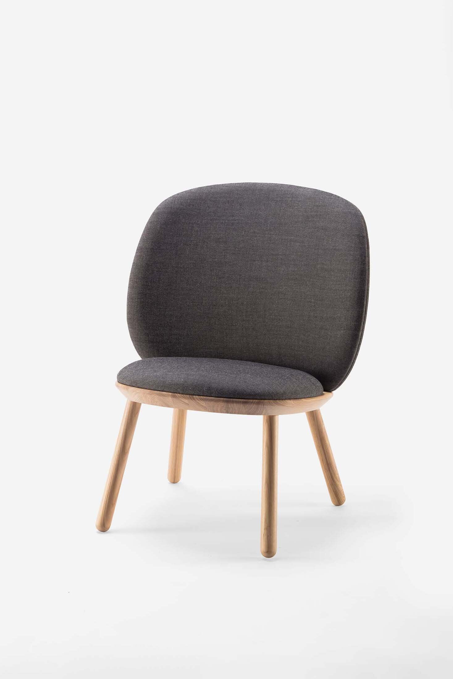 Naïve Low Chair featuring a large leather strap, wooden body, and textile upholstery, designed for comfort and style.