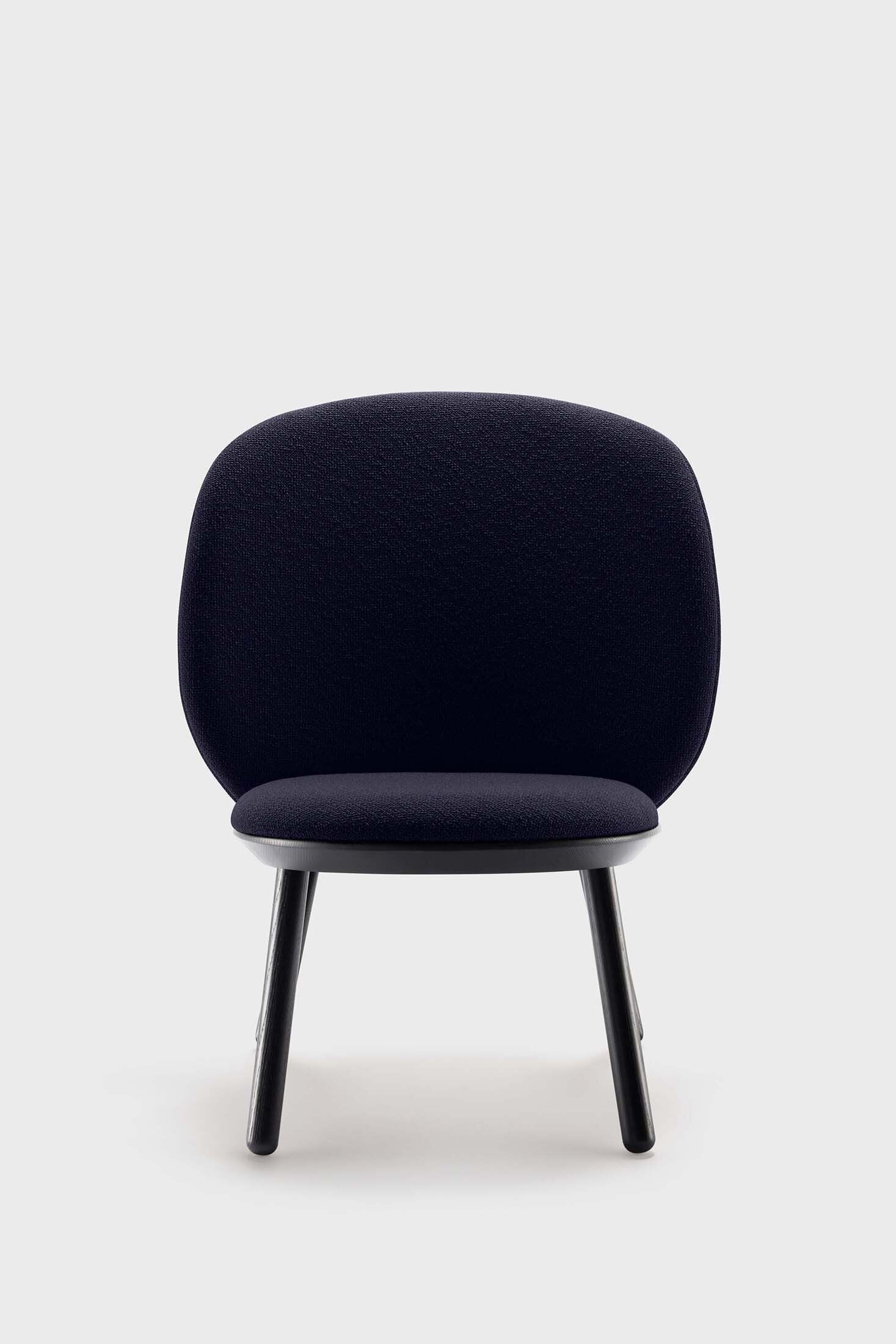 Naïve Low Chair featuring a large leather strap, wooden body, and textile upholstery, designed for comfort and style.