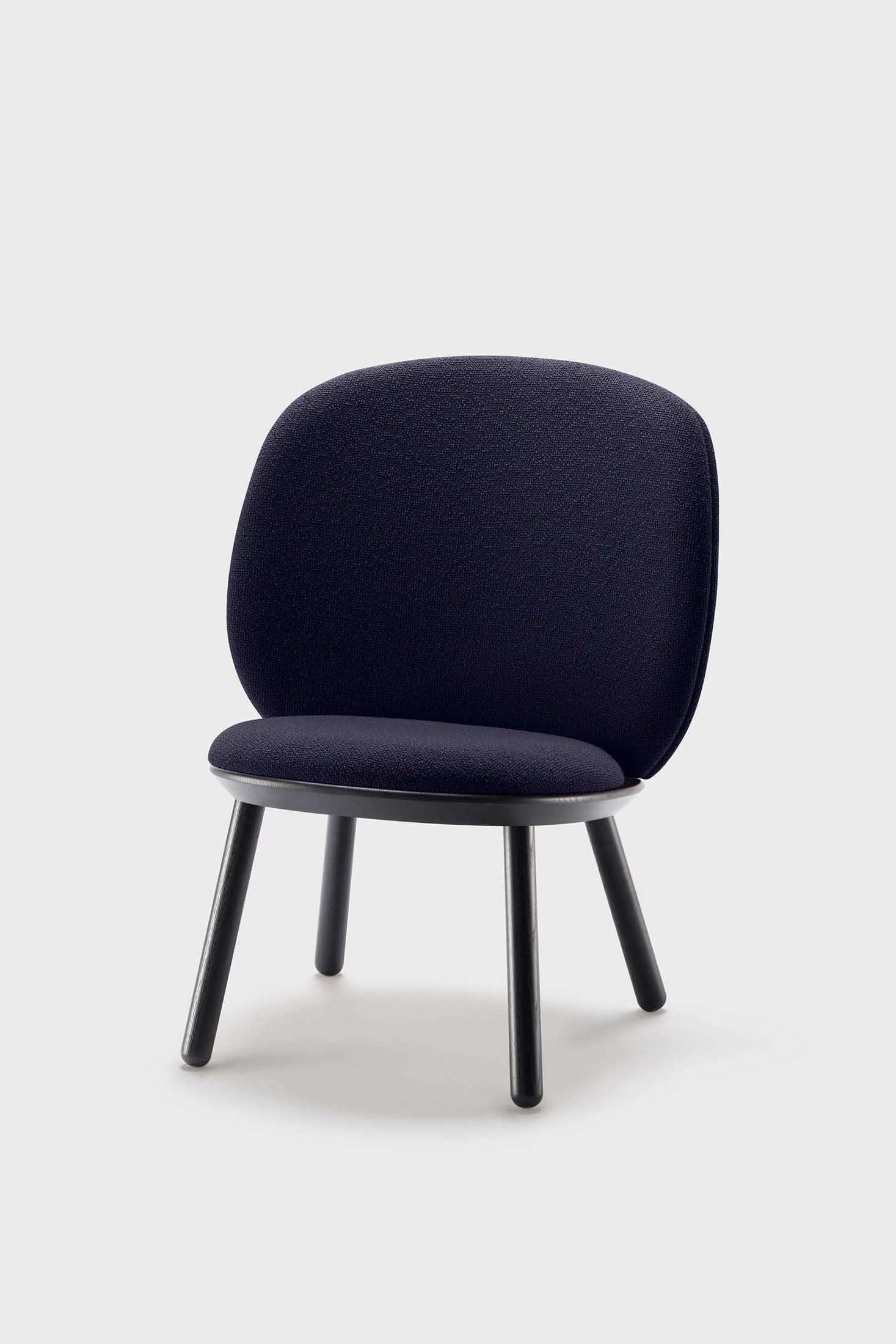 Naïve Low Chair featuring a large leather strap, wooden body, and textile upholstery, designed for comfort and style.