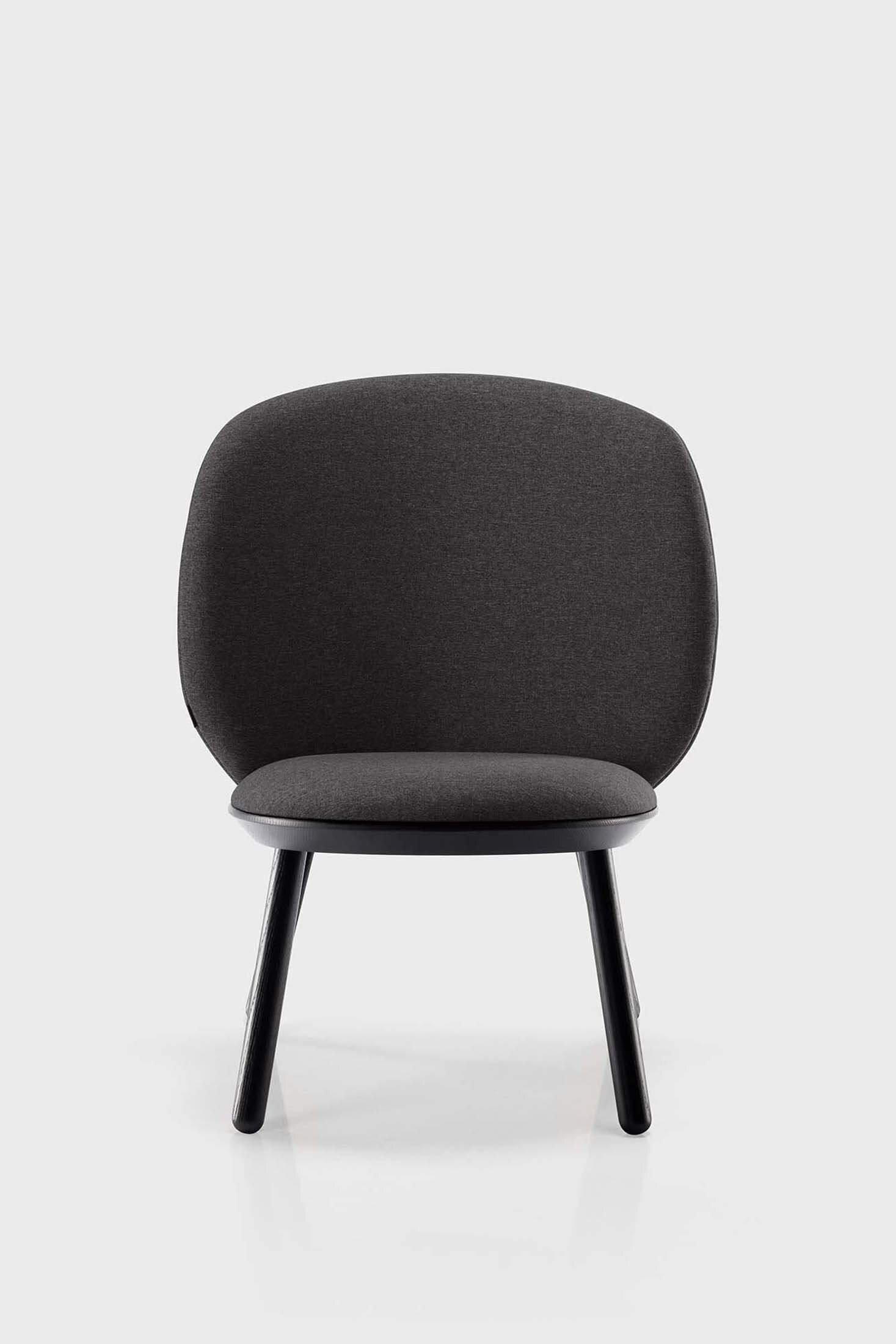 Naïve Low Chair featuring a large leather strap, wooden body, and textile upholstery, designed for comfort and style.