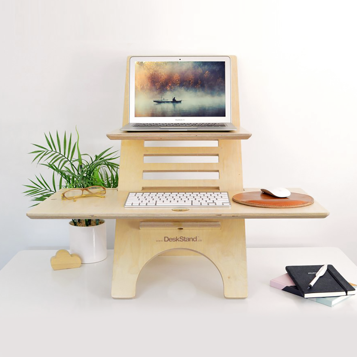 Original DeskStand - Adjustable Standing Desk featuring a sleek design with a built-in cable manager and smartphone holder, made from premium Baltic Birch plywood.