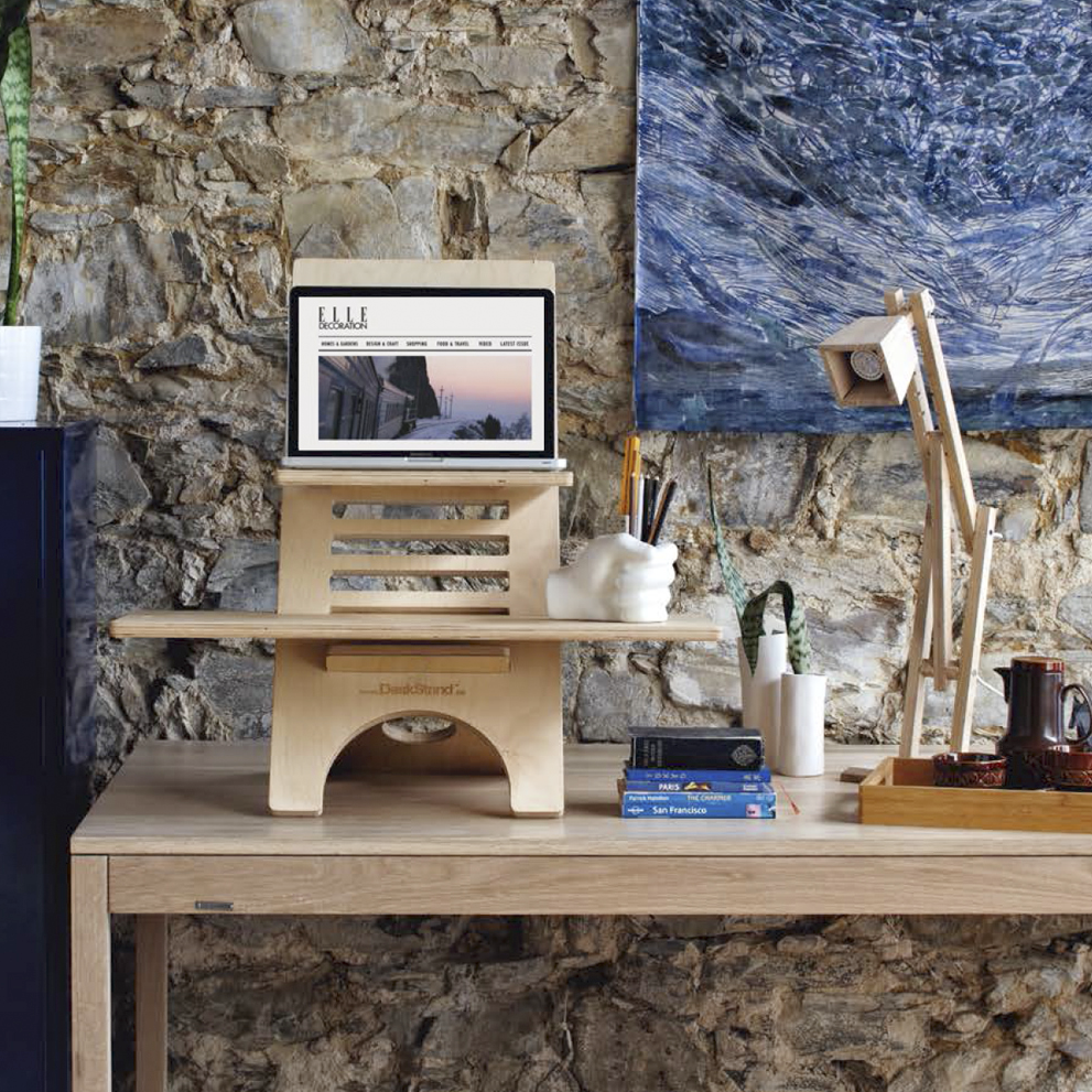 Original DeskStand - Adjustable Standing Desk featuring a sleek design with a built-in cable manager and smartphone holder, made from premium Baltic Birch plywood.