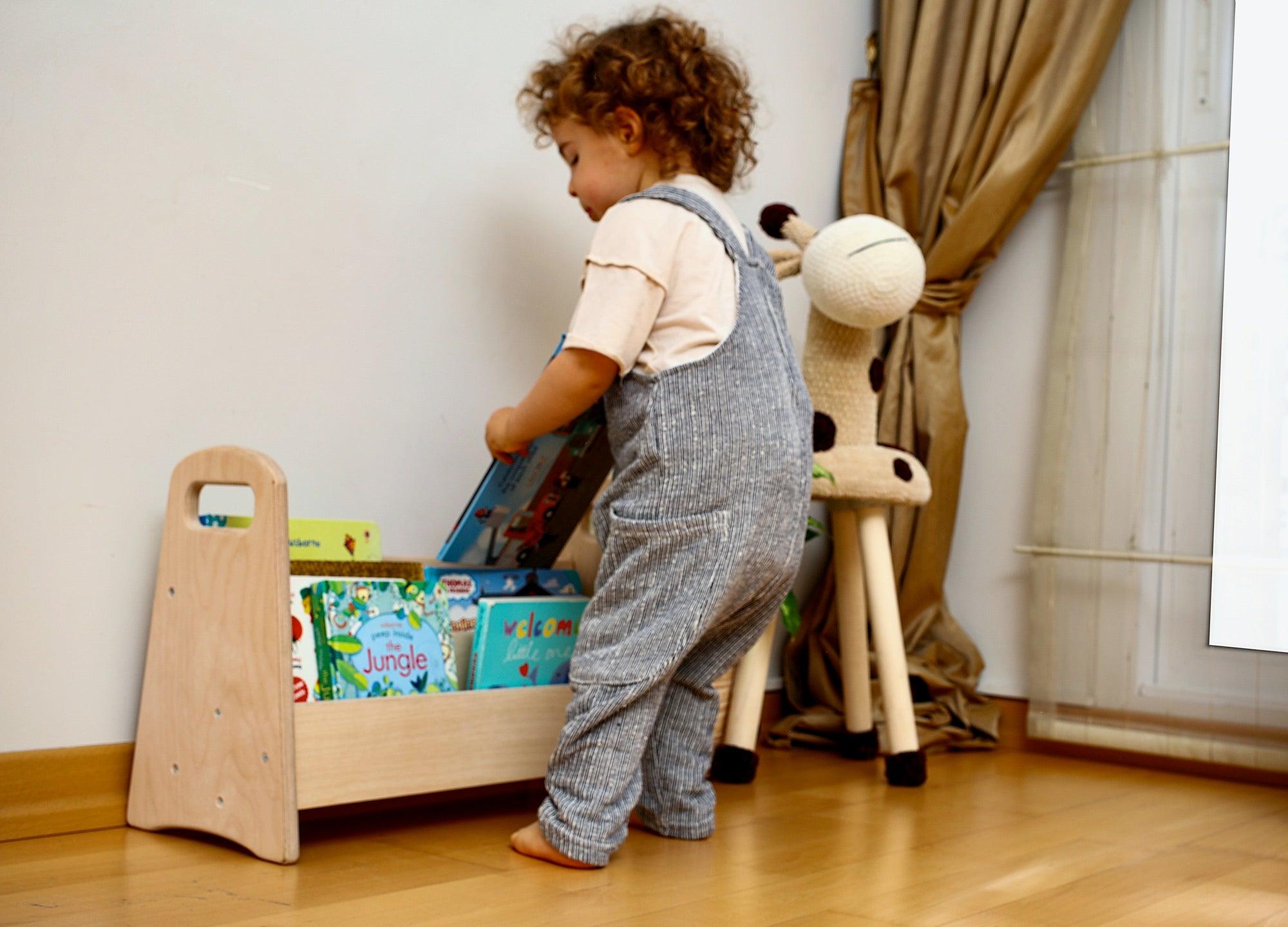 A small wooden bookshelf designed for children, featuring colorful books and a sturdy construction, perfect for encouraging reading and imagination.