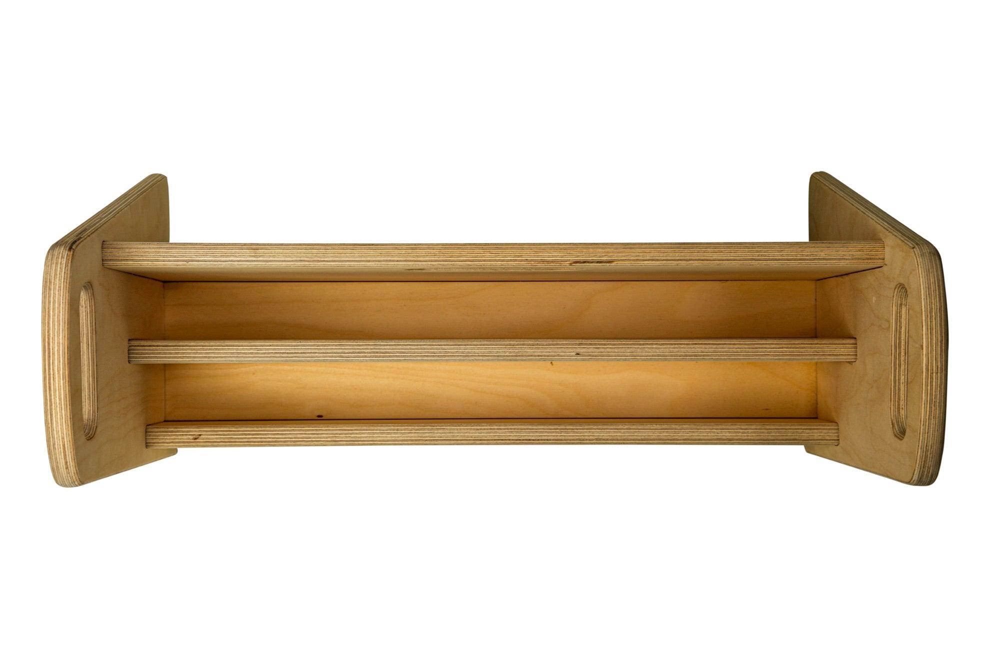 A small wooden bookshelf designed for children, featuring colorful books and a sturdy construction, perfect for encouraging reading and imagination.