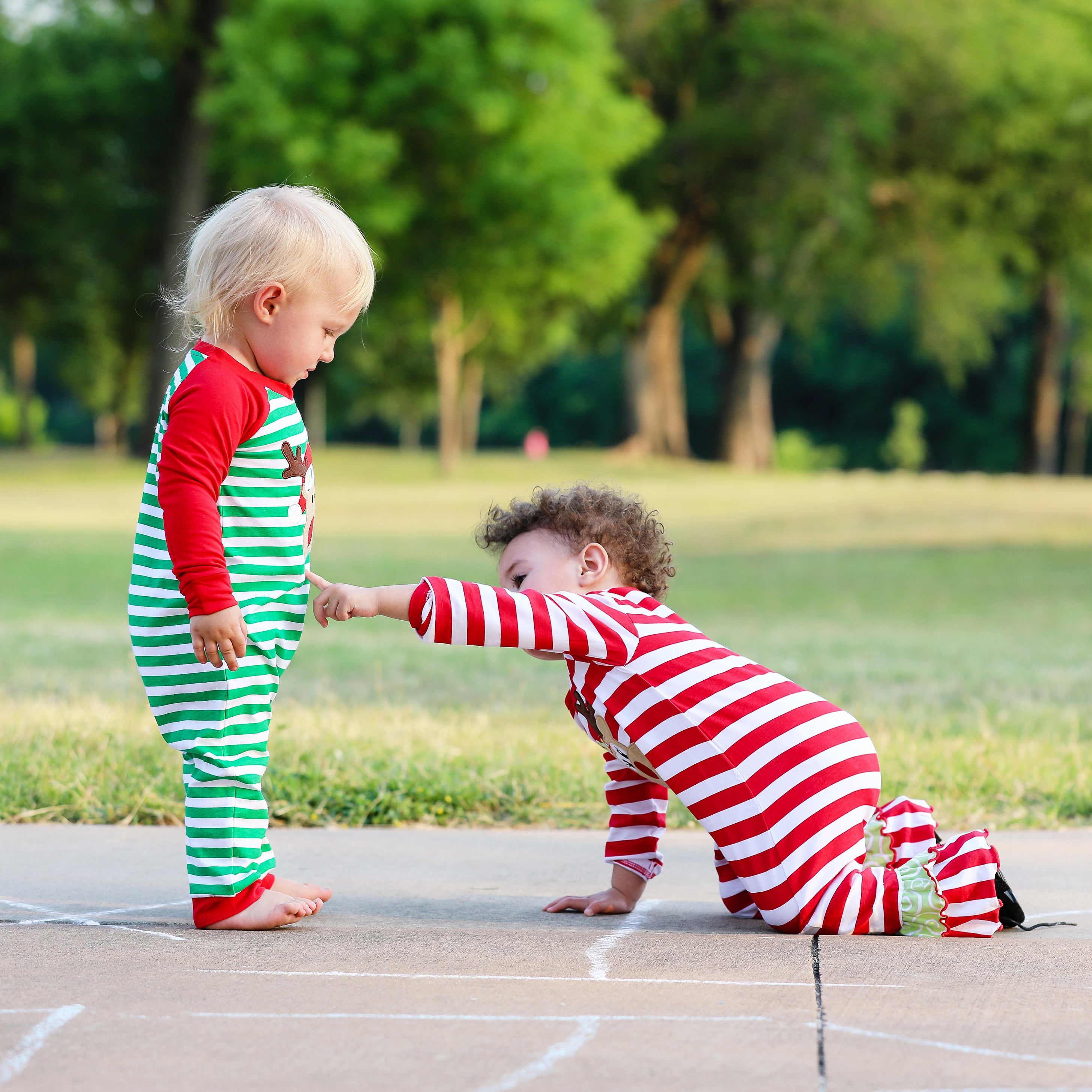 AnnLoren Baby Toddler Boys Unisex Long Sleeve Rudolf the Reindeer romper featuring red and green stripes with a reindeer appliqué.