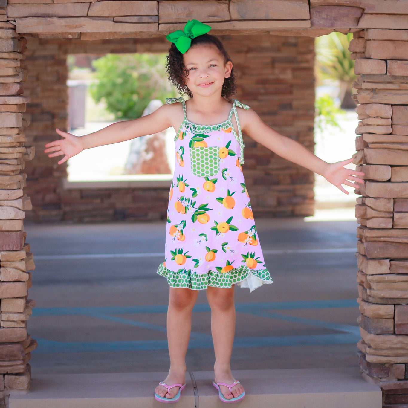 AnnLoren Big Little Girls Pretty as a Peach Pink Spaghetti Strap Dress featuring green polka dot ruffles and a chest pocket.