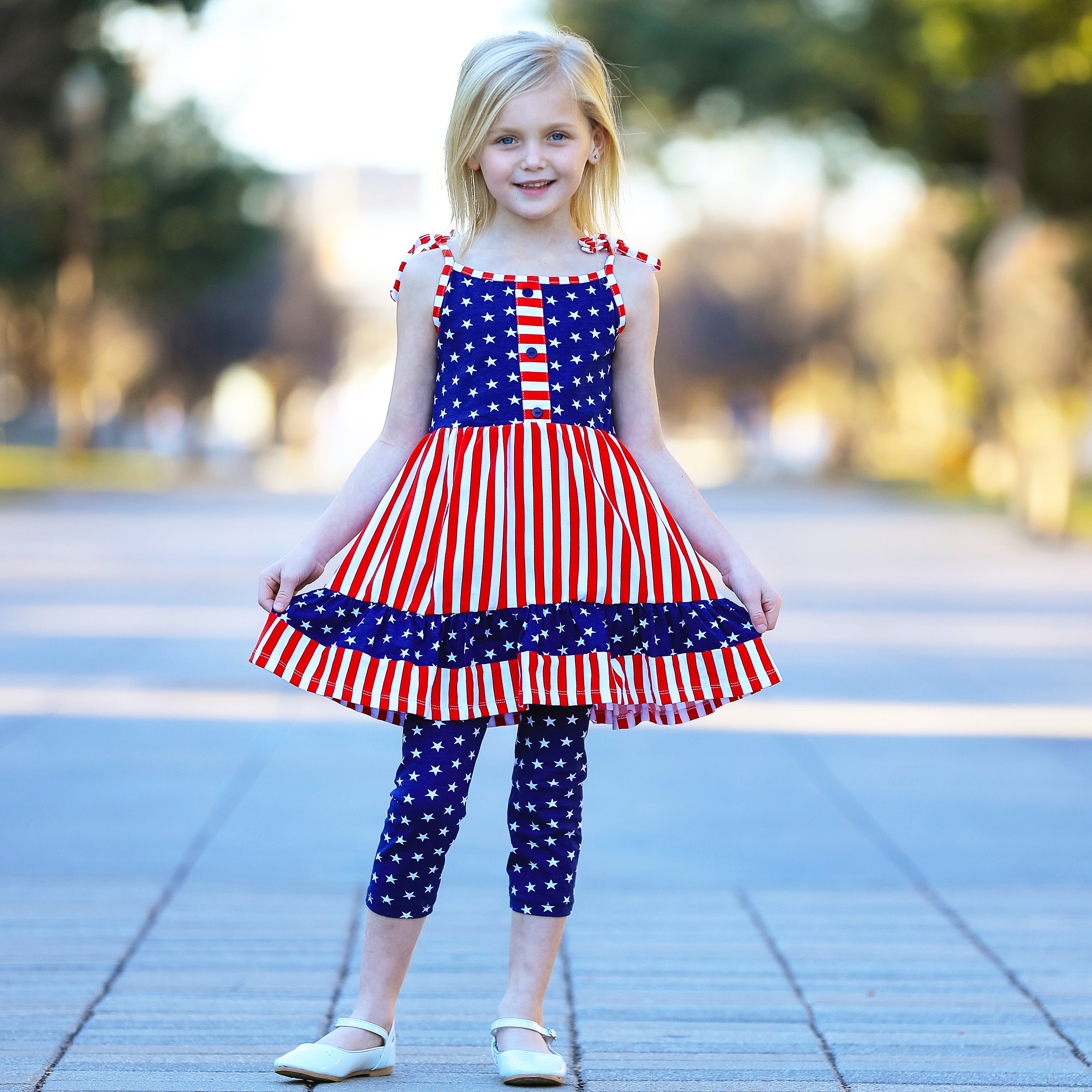 AnnLoren Girls 4th of July dress featuring red and white stripes with blue stars, paired with blue star capri leggings.