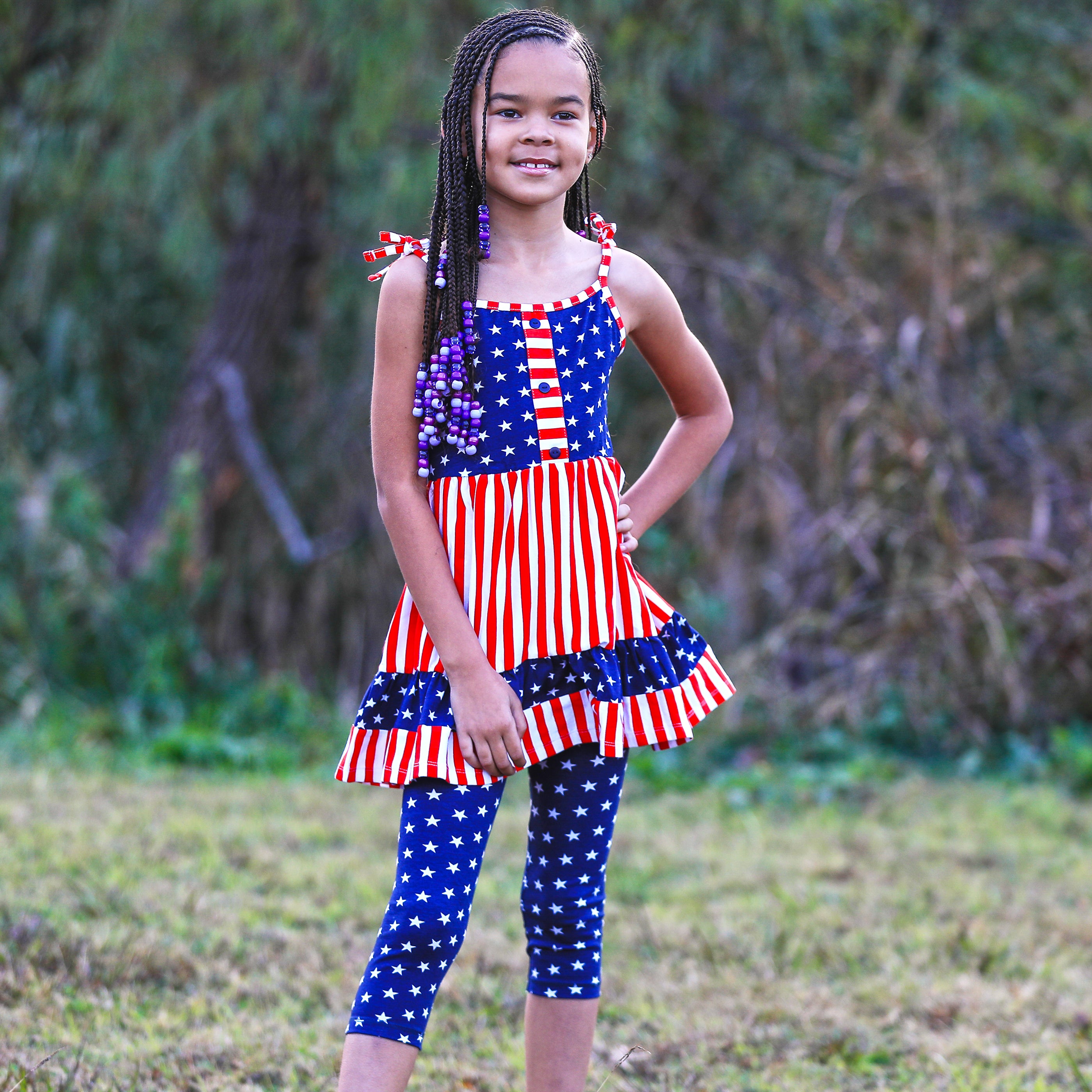 AnnLoren Girls 4th of July dress featuring red and white stripes with blue stars, paired with blue star capri leggings.