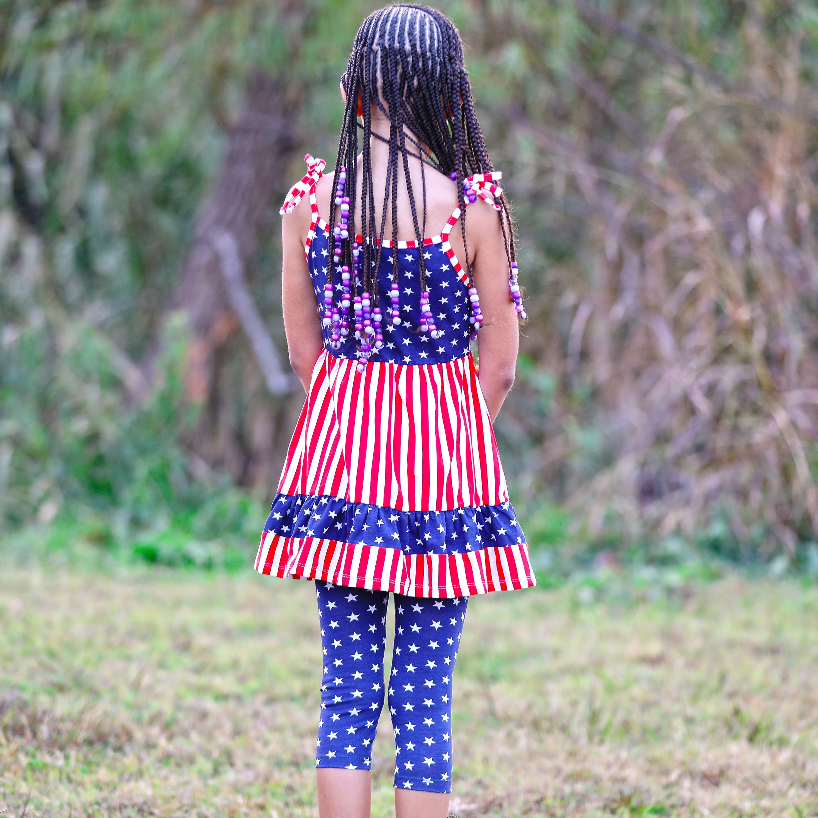 AnnLoren Girls 4th of July dress featuring red and white stripes with blue stars, paired with blue star capri leggings.