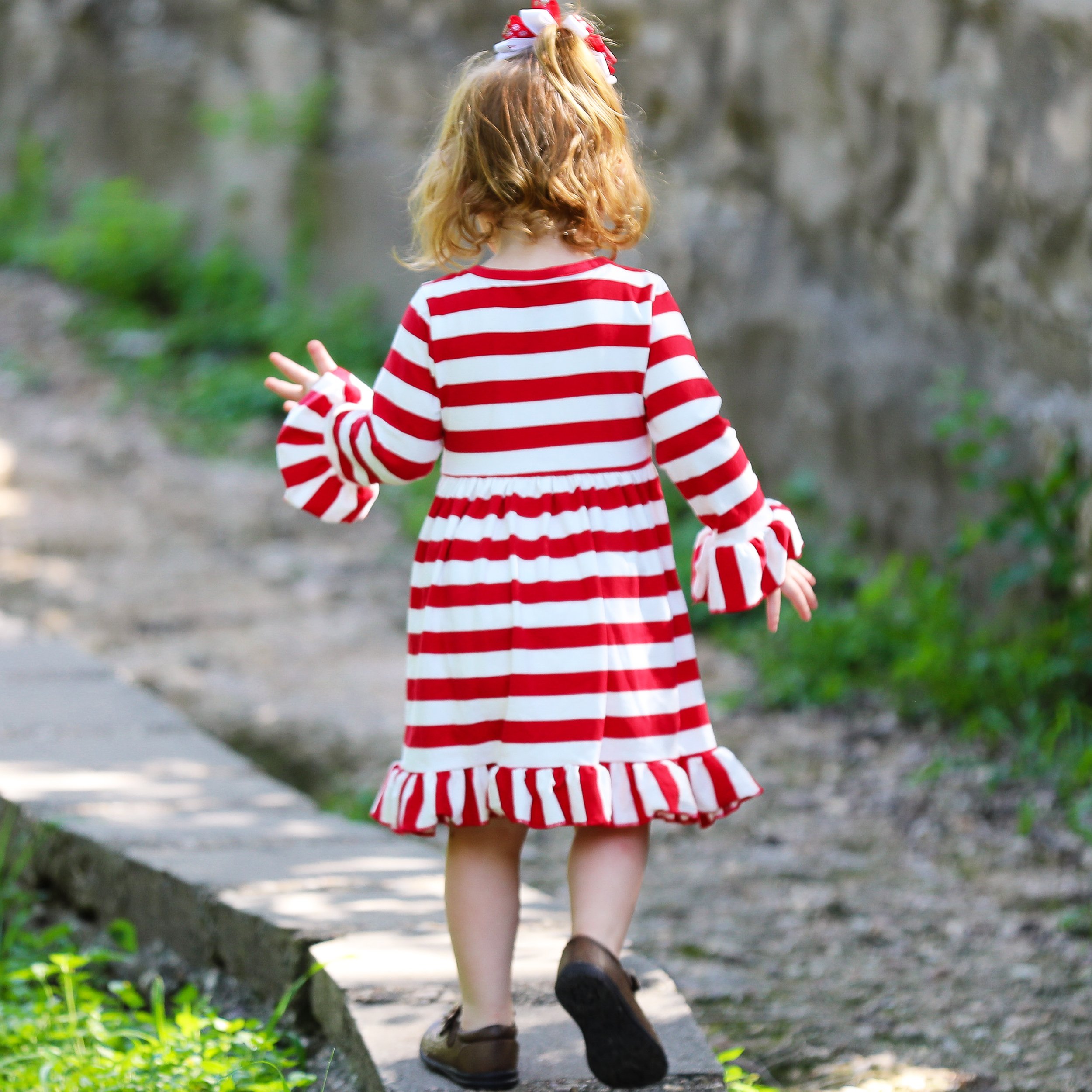 AnnLoren Girls Boutique Red Stripe Christmas dress featuring Rudolf the Reindeer applique and ruffled hem, perfect for festive occasions.