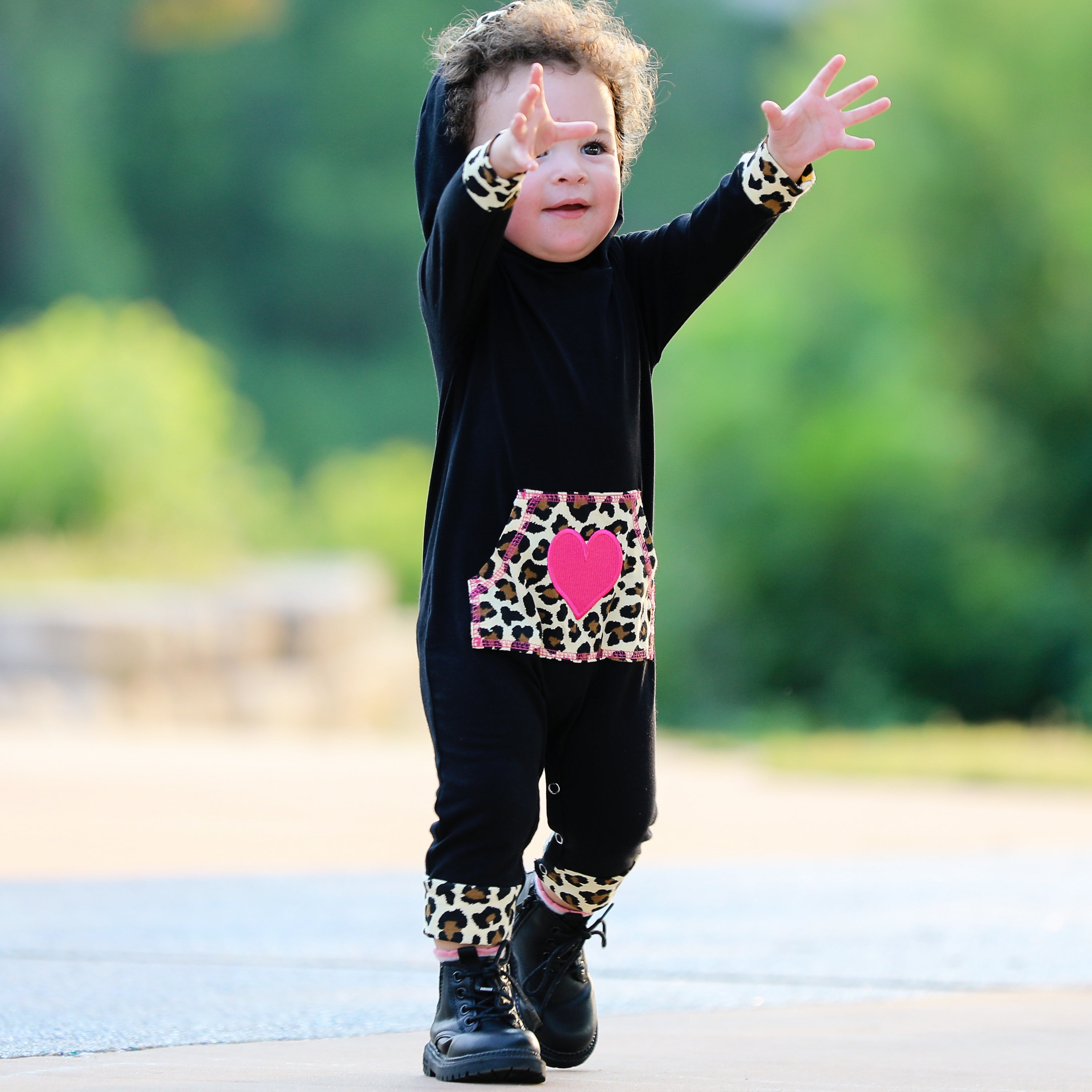 AnnLoren Girls Long Sleeve Leopard Heart Romper Hoodie featuring a black design with leopard ears and a kangaroo pocket.