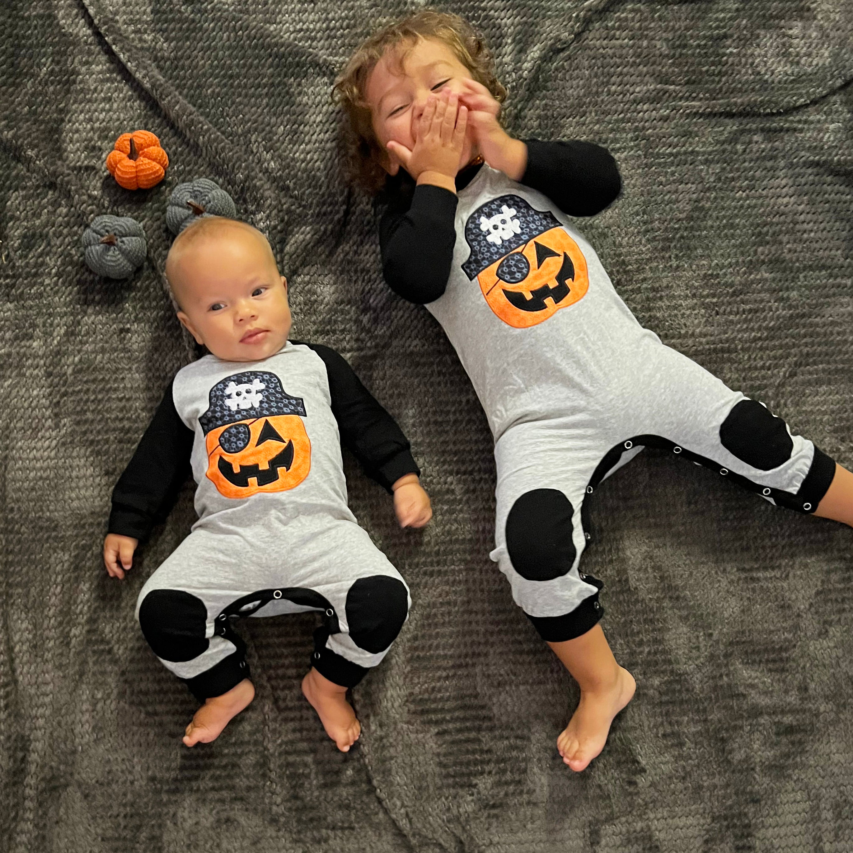 AnnLoren Halloween Pirate Jack O Lantern Long Sleeve Romper for baby boys, featuring cute knee patches and snaps for easy dressing.