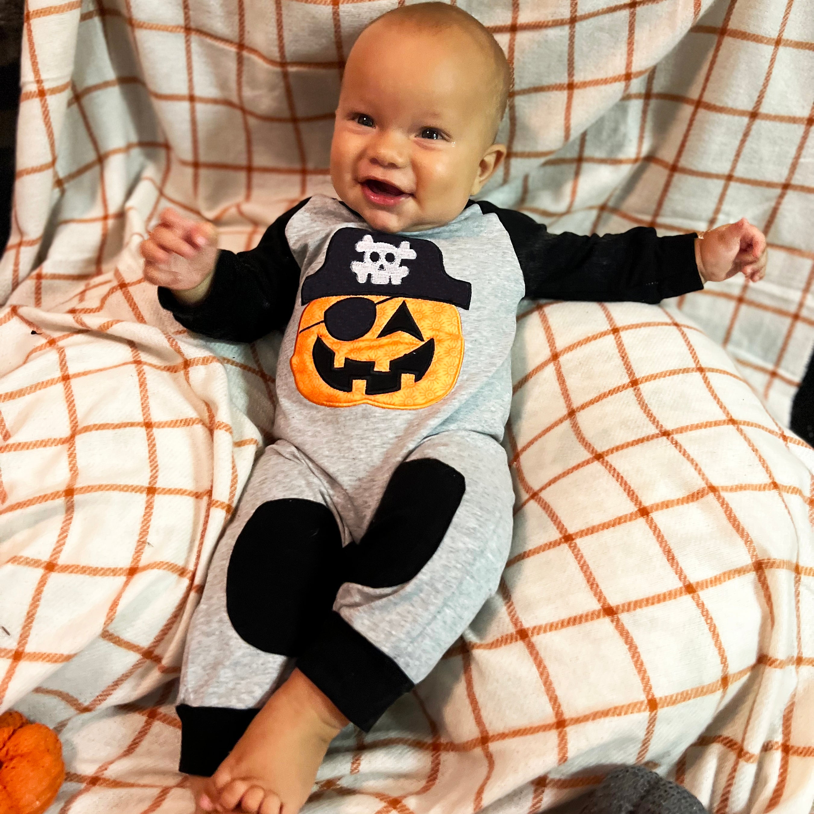 AnnLoren Halloween Pirate Jack O Lantern Long Sleeve Romper for baby boys, featuring cute knee patches and snaps for easy dressing.