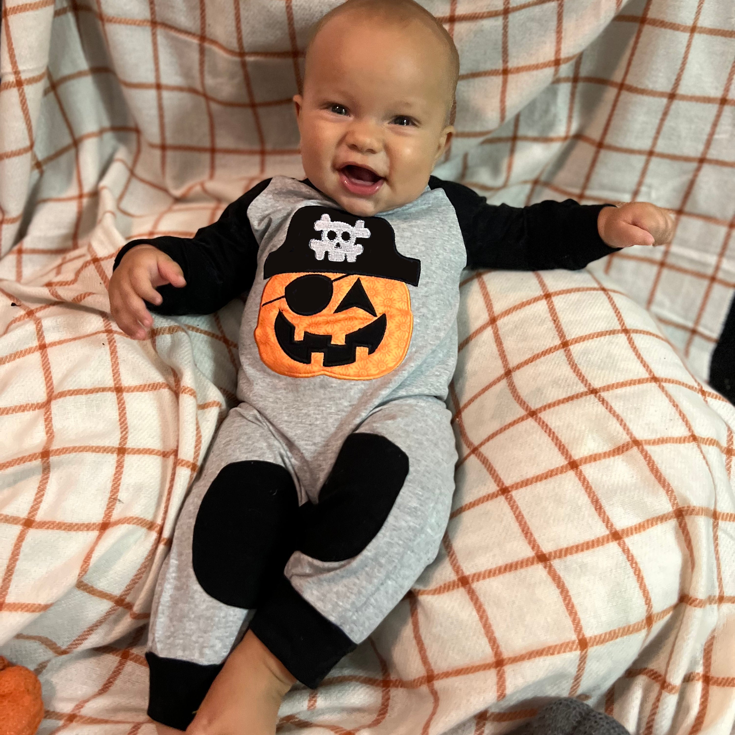 AnnLoren Halloween Pirate Jack O Lantern Long Sleeve Romper for baby boys, featuring cute knee patches and snaps for easy dressing.