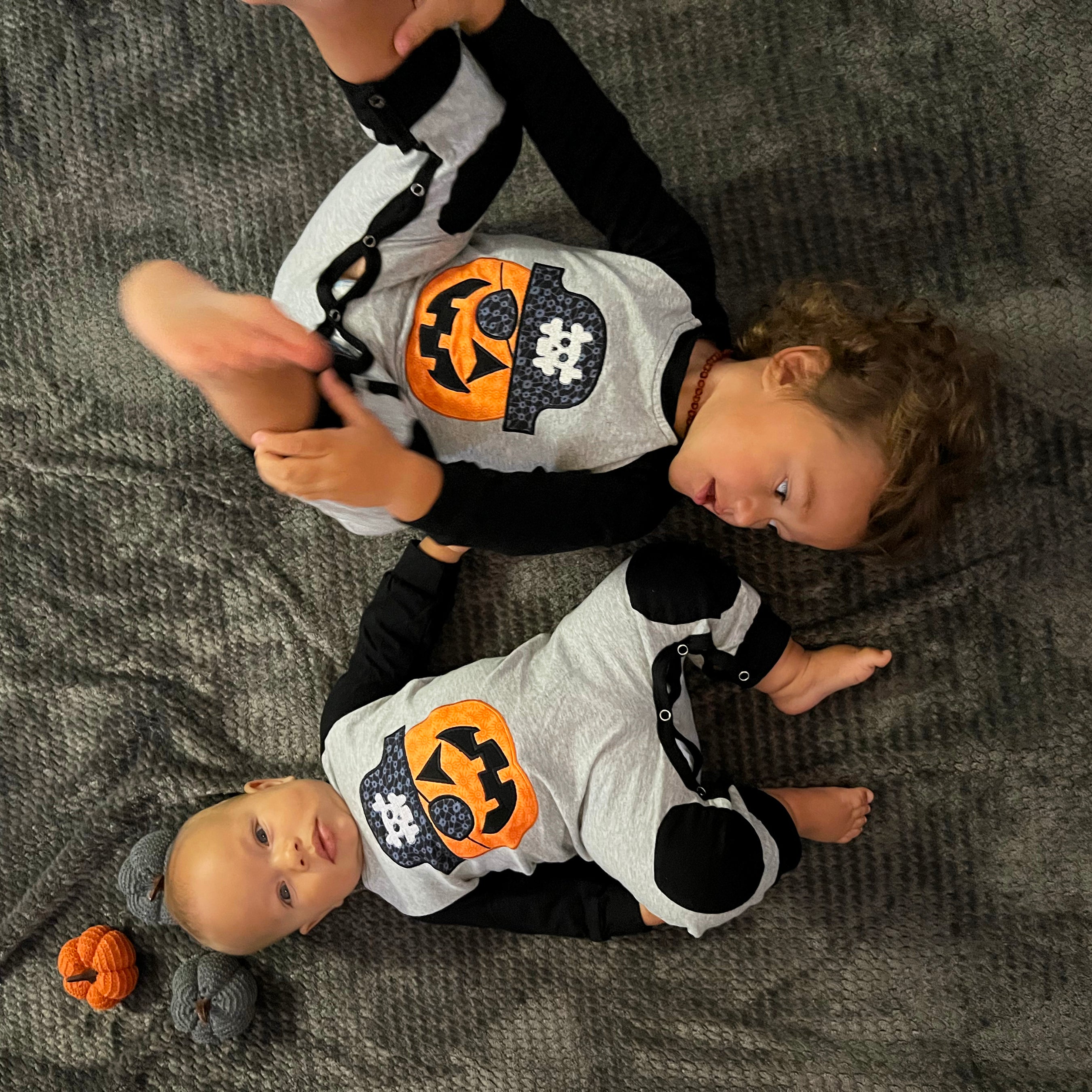 AnnLoren Halloween Pirate Jack O Lantern Long Sleeve Romper for baby boys, featuring cute knee patches and snaps for easy dressing.
