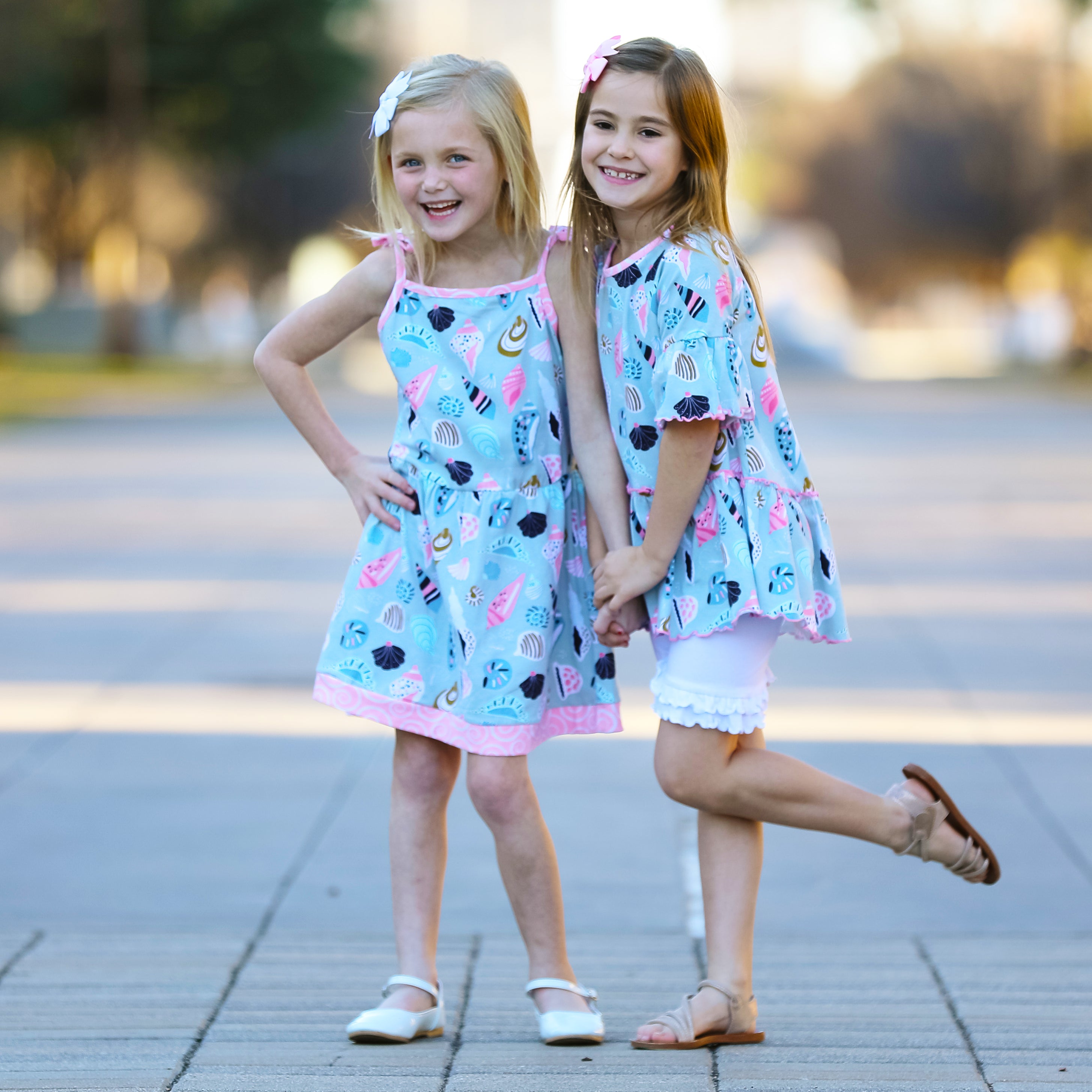 AnnLoren Little & Big Girls Seashells Dress featuring spaghetti straps and pink swirl trim, made from soft cotton knit fabric.