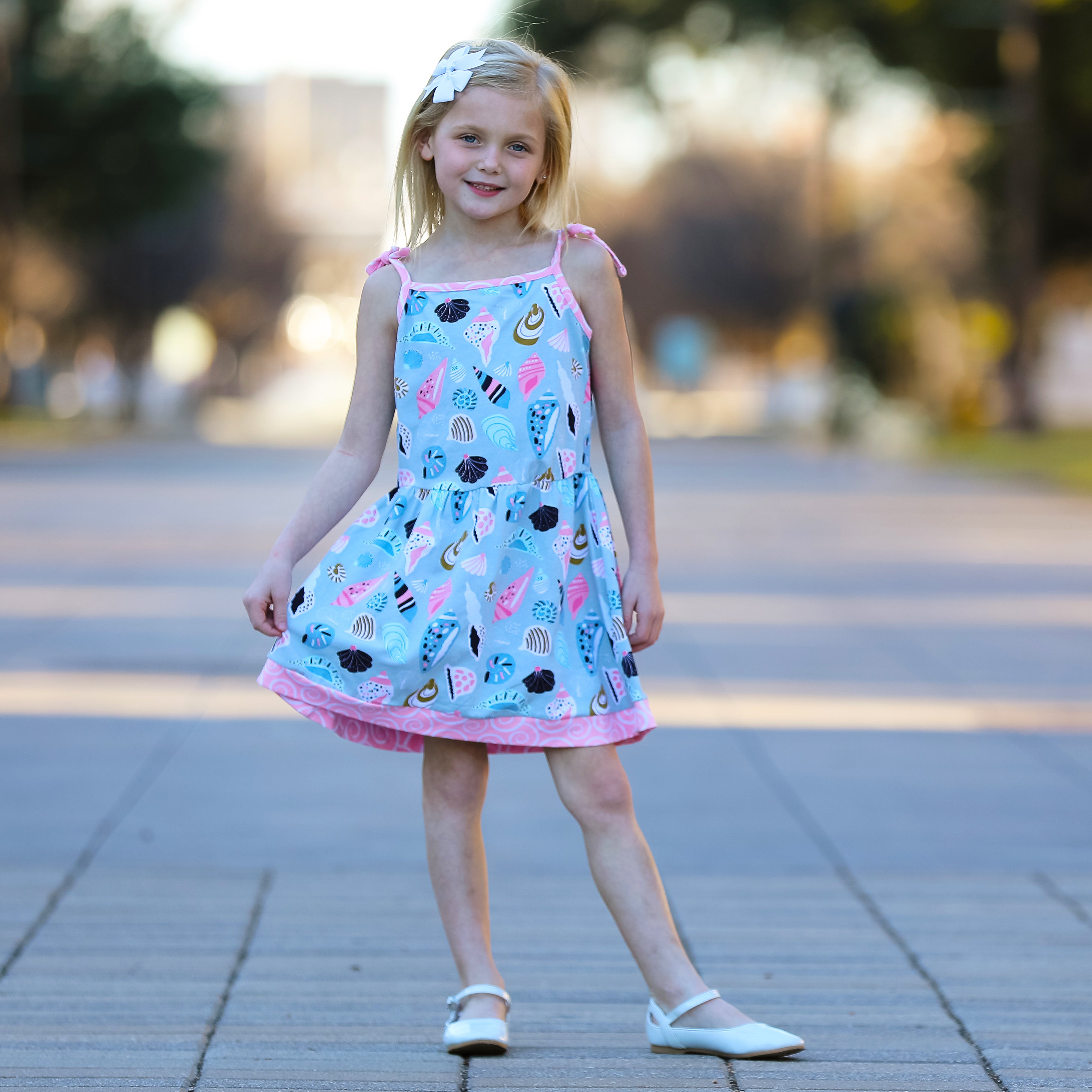 AnnLoren Little & Big Girls Seashells Dress featuring spaghetti straps and pink swirl trim, made from soft cotton knit fabric.