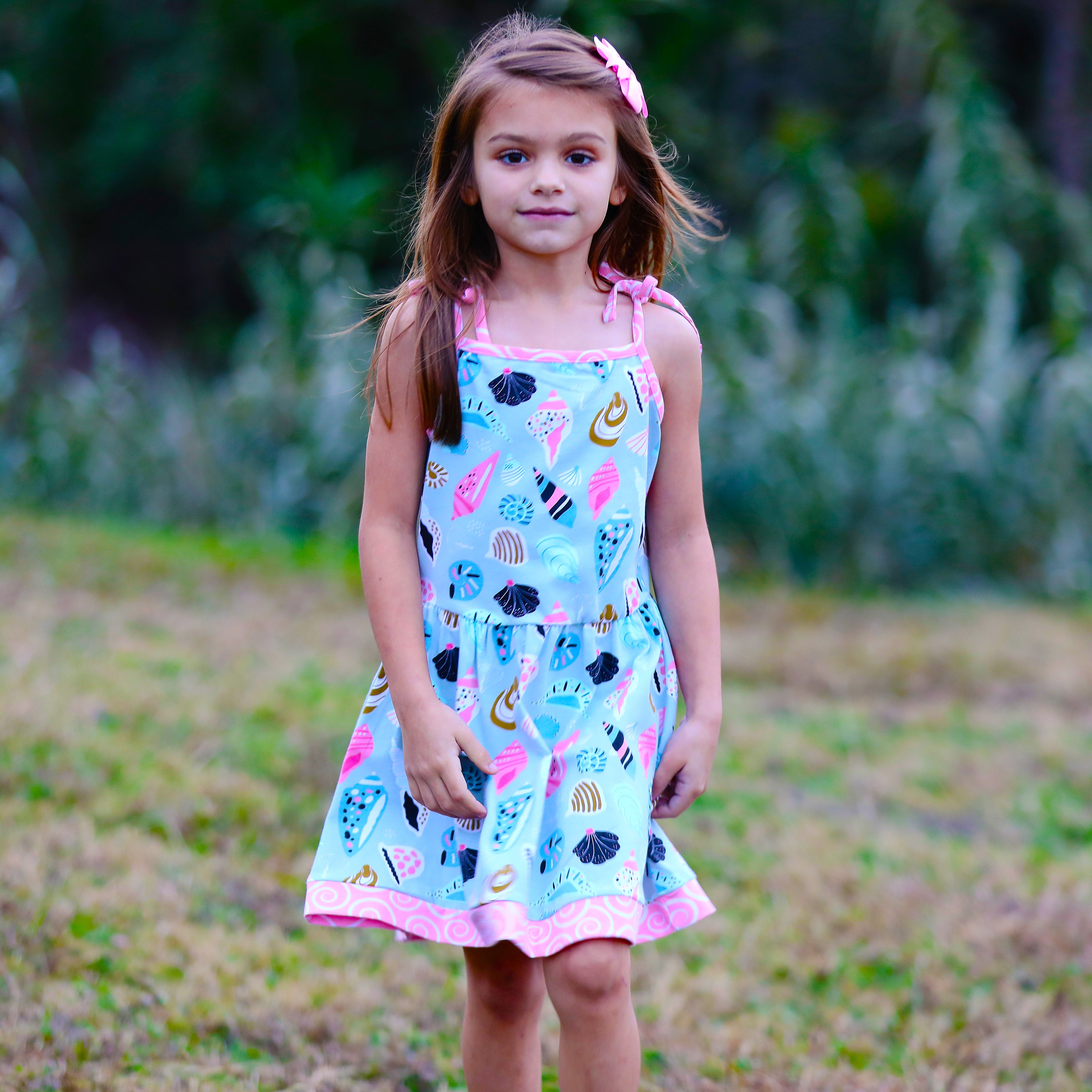 AnnLoren Little & Big Girls Seashells Dress featuring spaghetti straps and pink swirl trim, made from soft cotton knit fabric.