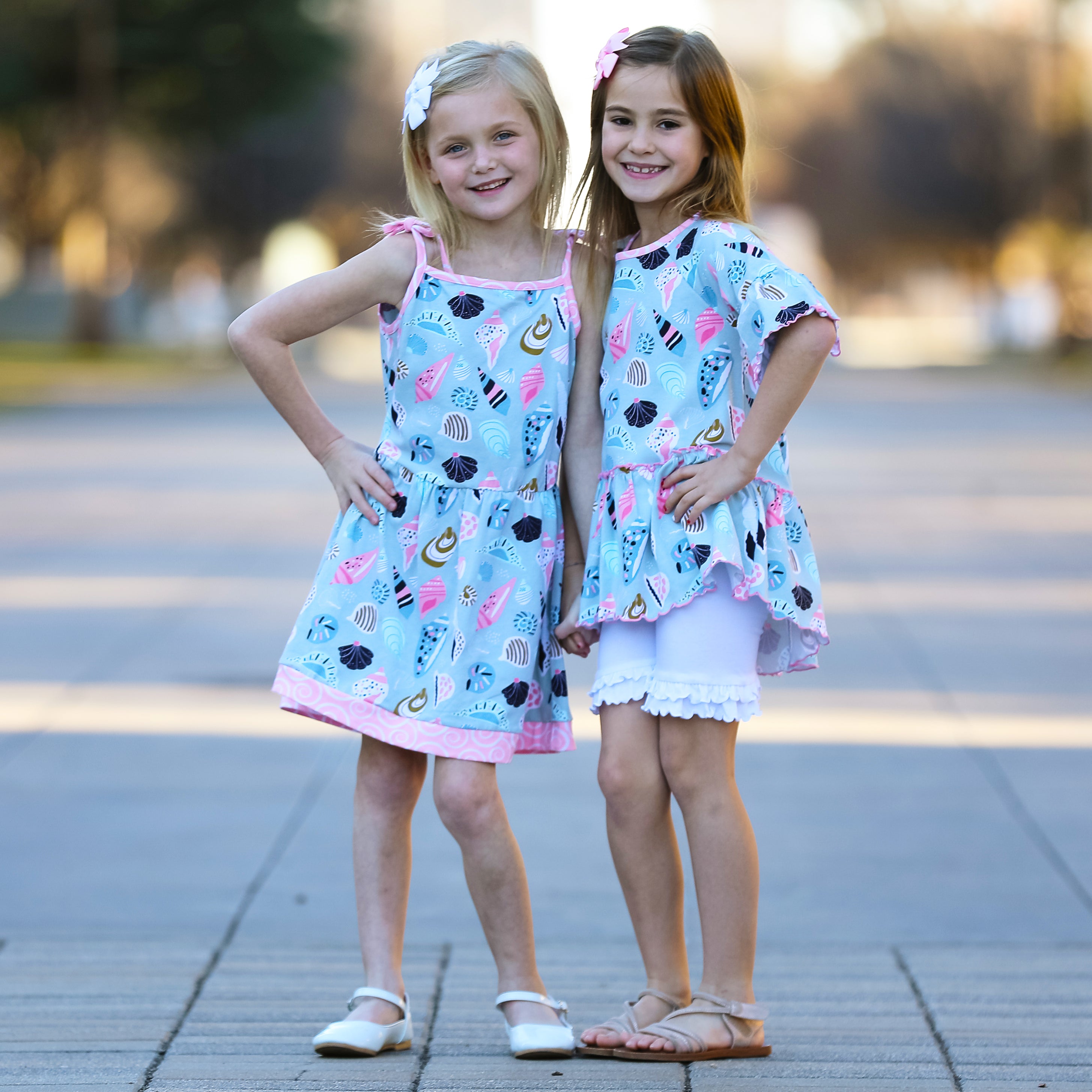 AnnLoren Little & Big Girls Seashells Dress featuring spaghetti straps and pink swirl trim, made from soft cotton knit fabric.