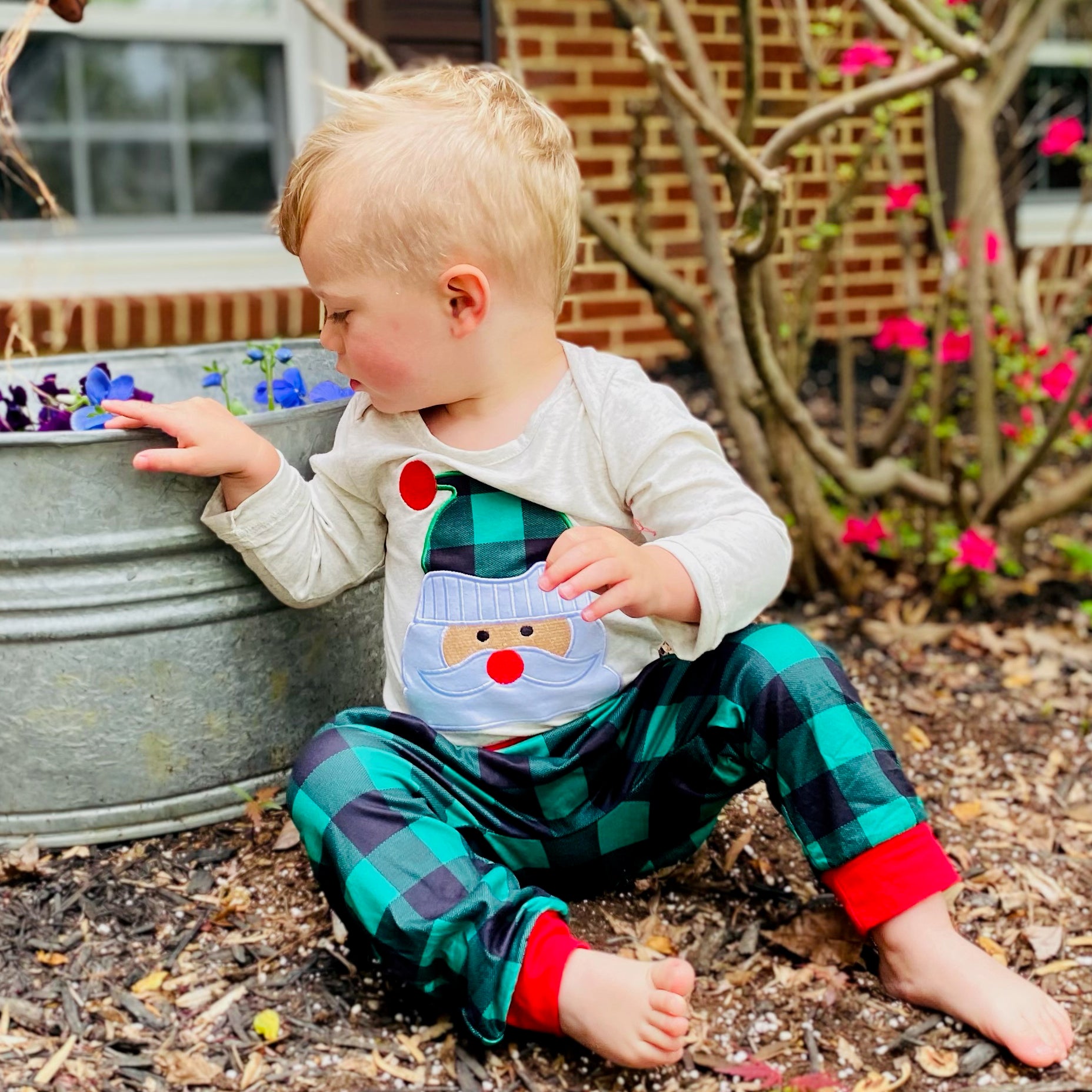 Baby boys holiday outfit featuring Santa Claus applique onesie and plaid jogger pants with red trim, perfect for Christmas celebrations.