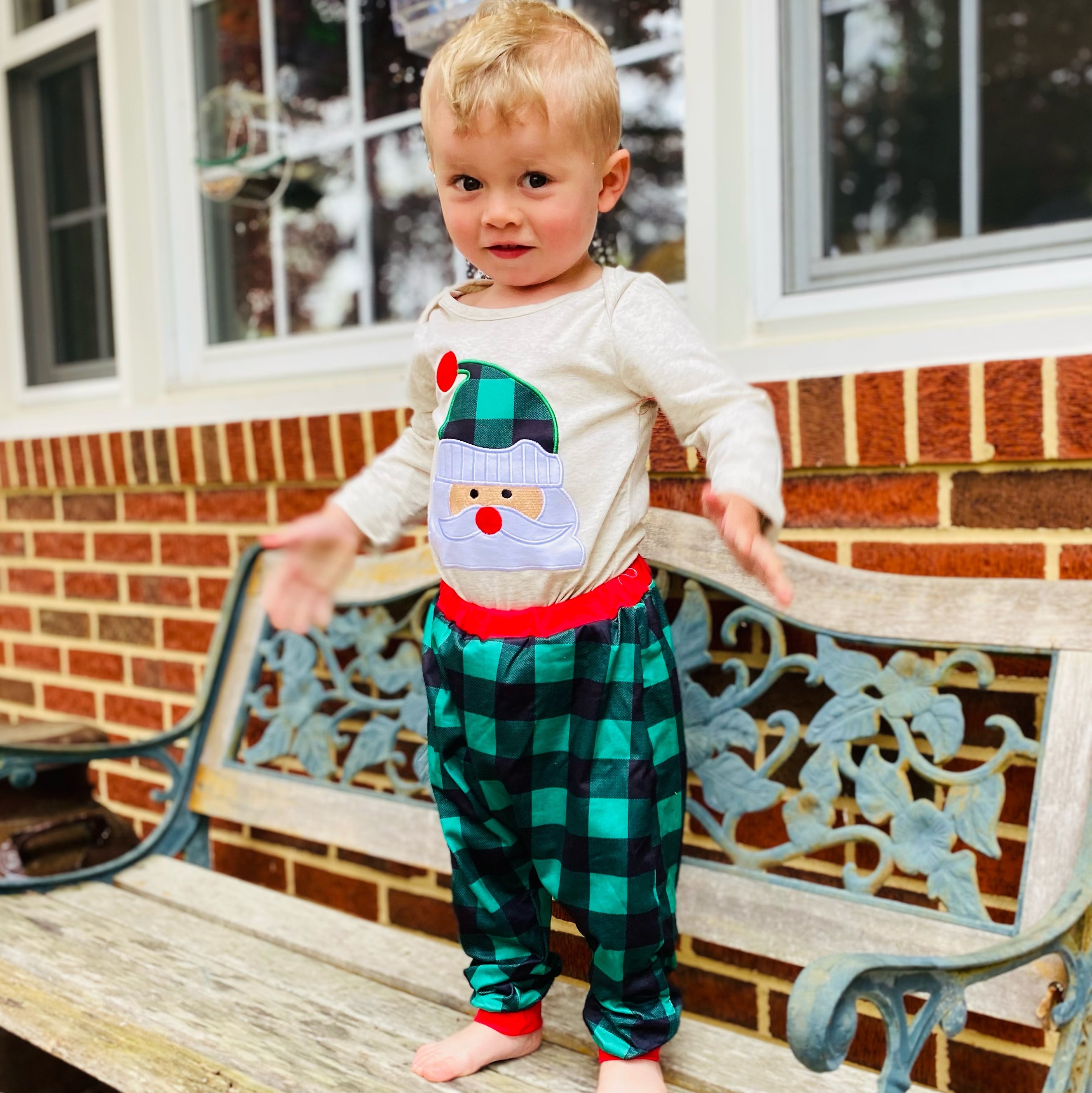 Baby boys holiday outfit featuring Santa Claus applique onesie and plaid jogger pants with red trim, perfect for Christmas celebrations.