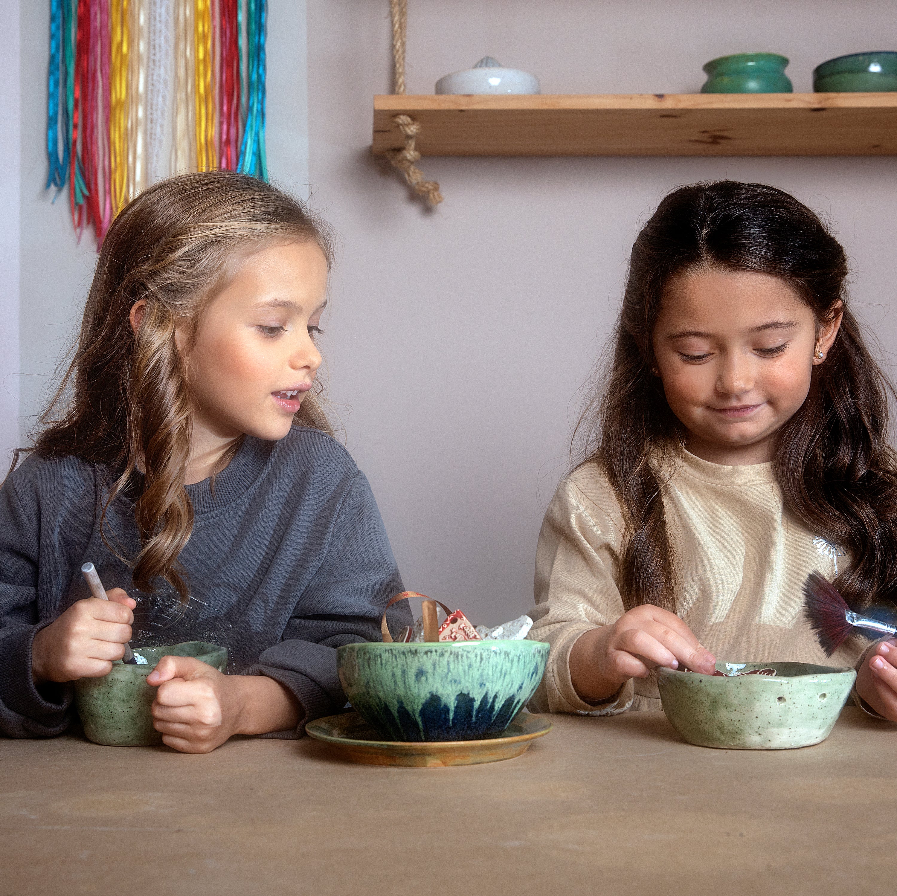 A stylish winter dress for girls in midnight grey, featuring long sleeves, a ribbed round collar, and side pockets, made from soft brushed cotton fleece.