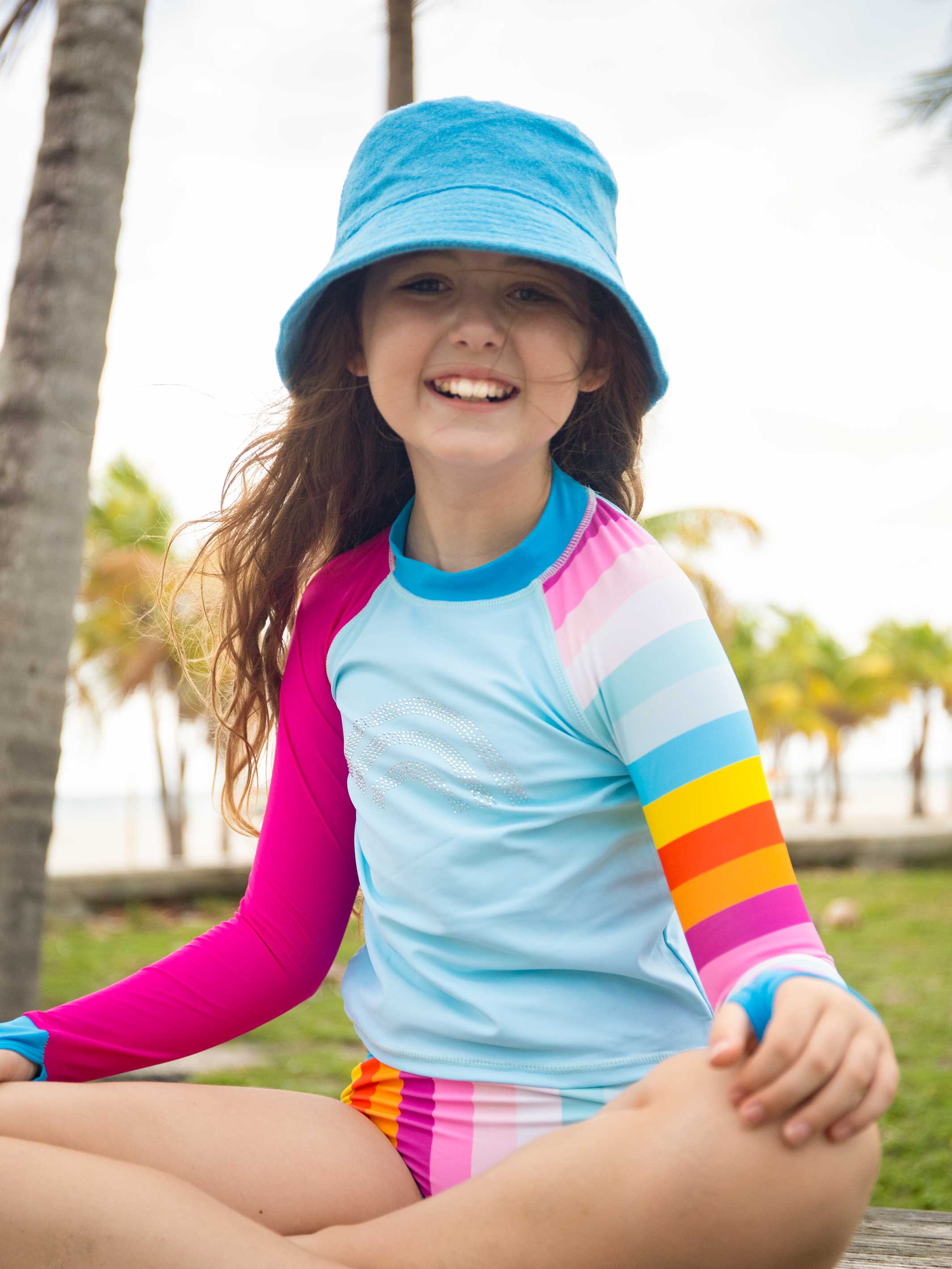 ELVIE Multicolor Rhinestone Print Rash Guard Set featuring bold stripes and mid-rise bikini bottoms, perfect for summer activities.