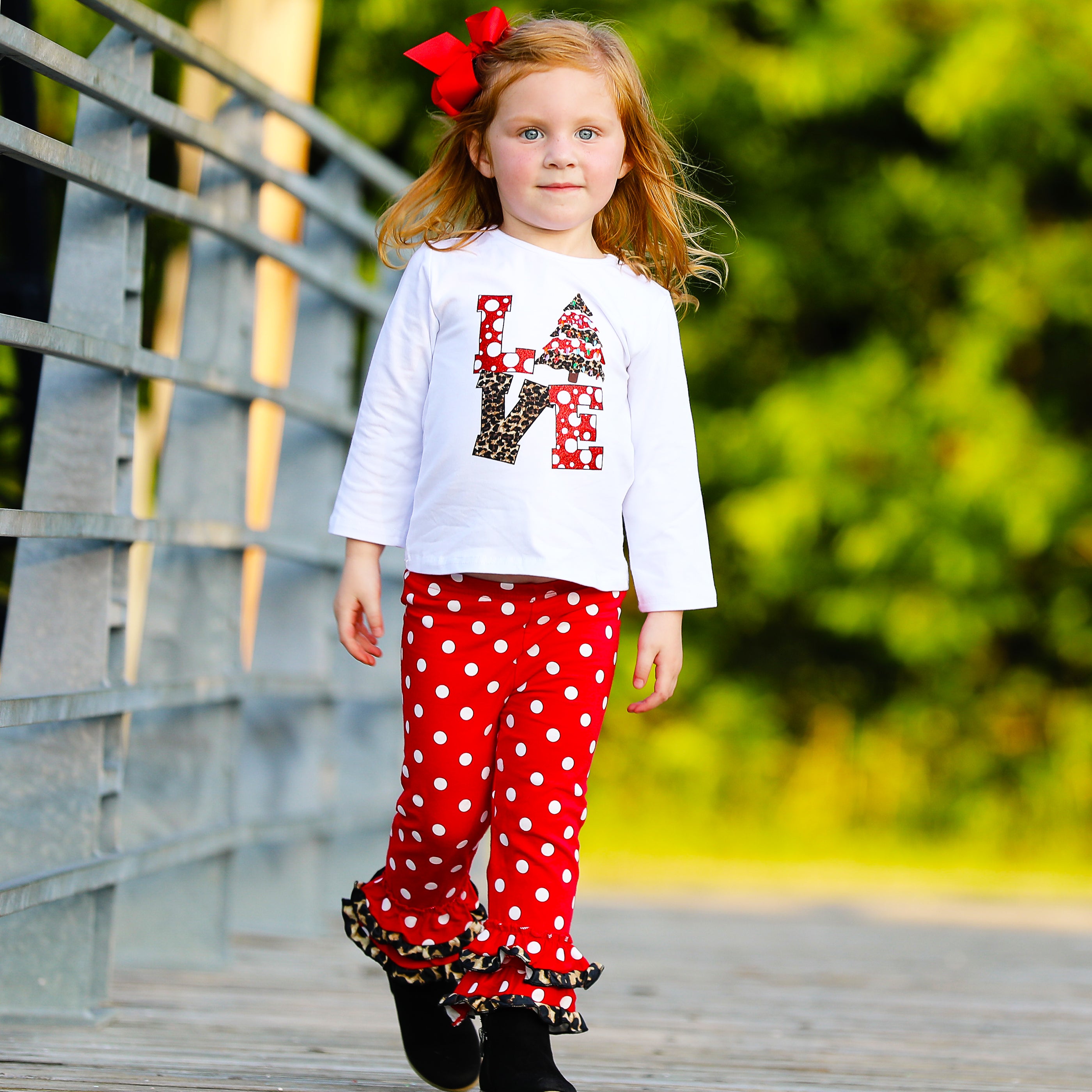 Girls LOVE Christmas outfit featuring a top with LOVE applique and red polka dot ruffle pants, perfect for festive occasions.