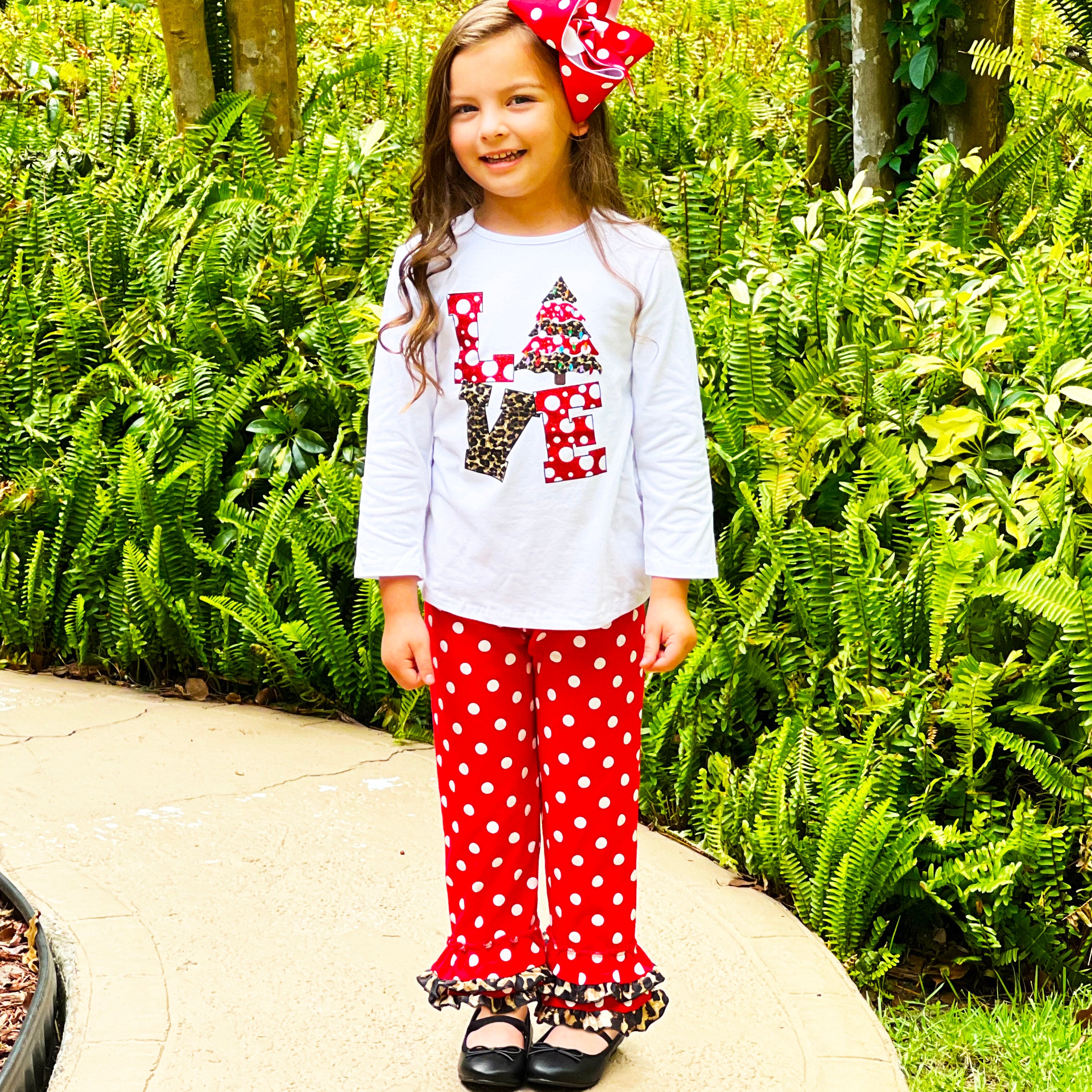 Girls LOVE Christmas outfit featuring a top with LOVE applique and red polka dot ruffle pants, perfect for festive occasions.