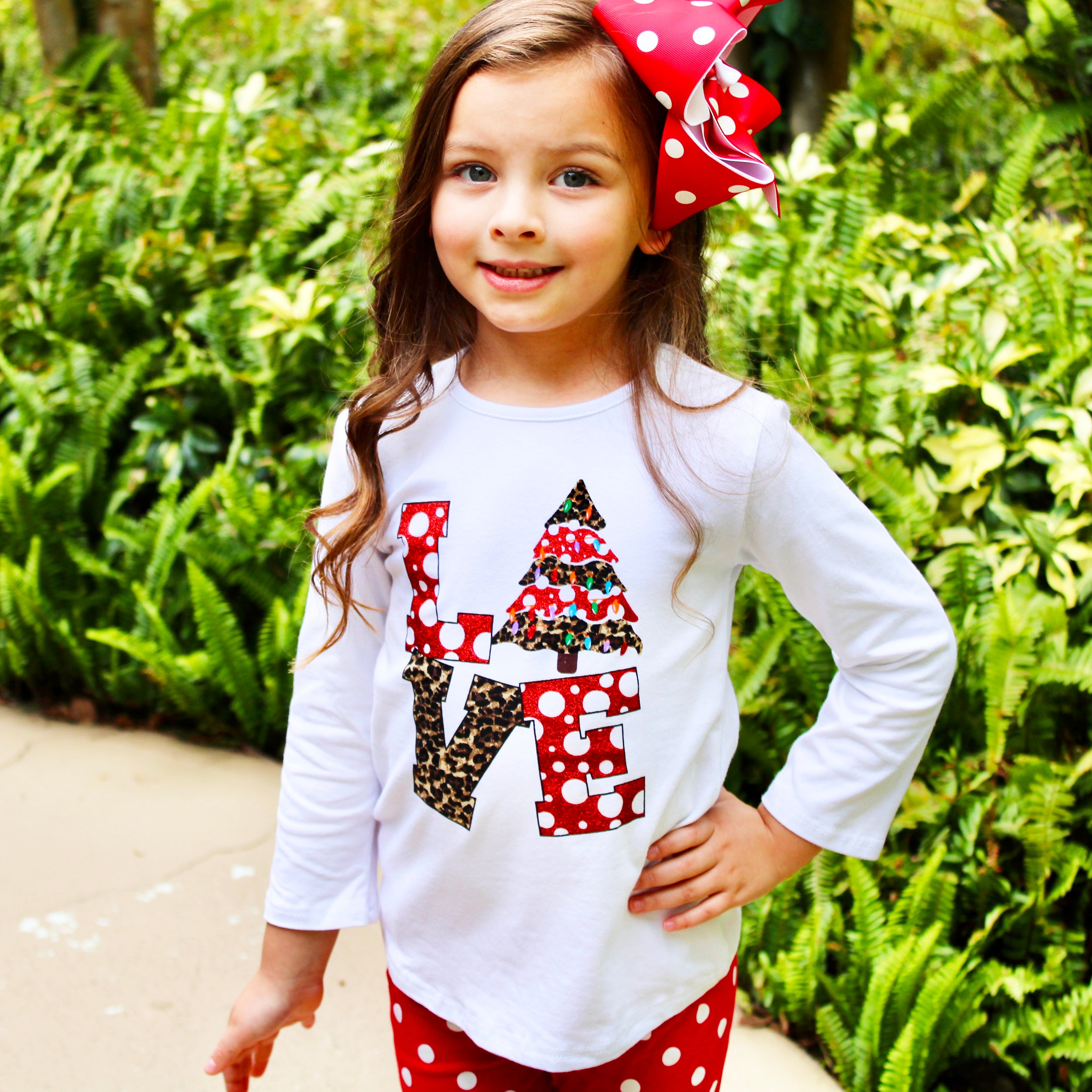 Girls LOVE Christmas outfit featuring a top with LOVE applique and red polka dot ruffle pants, perfect for festive occasions.