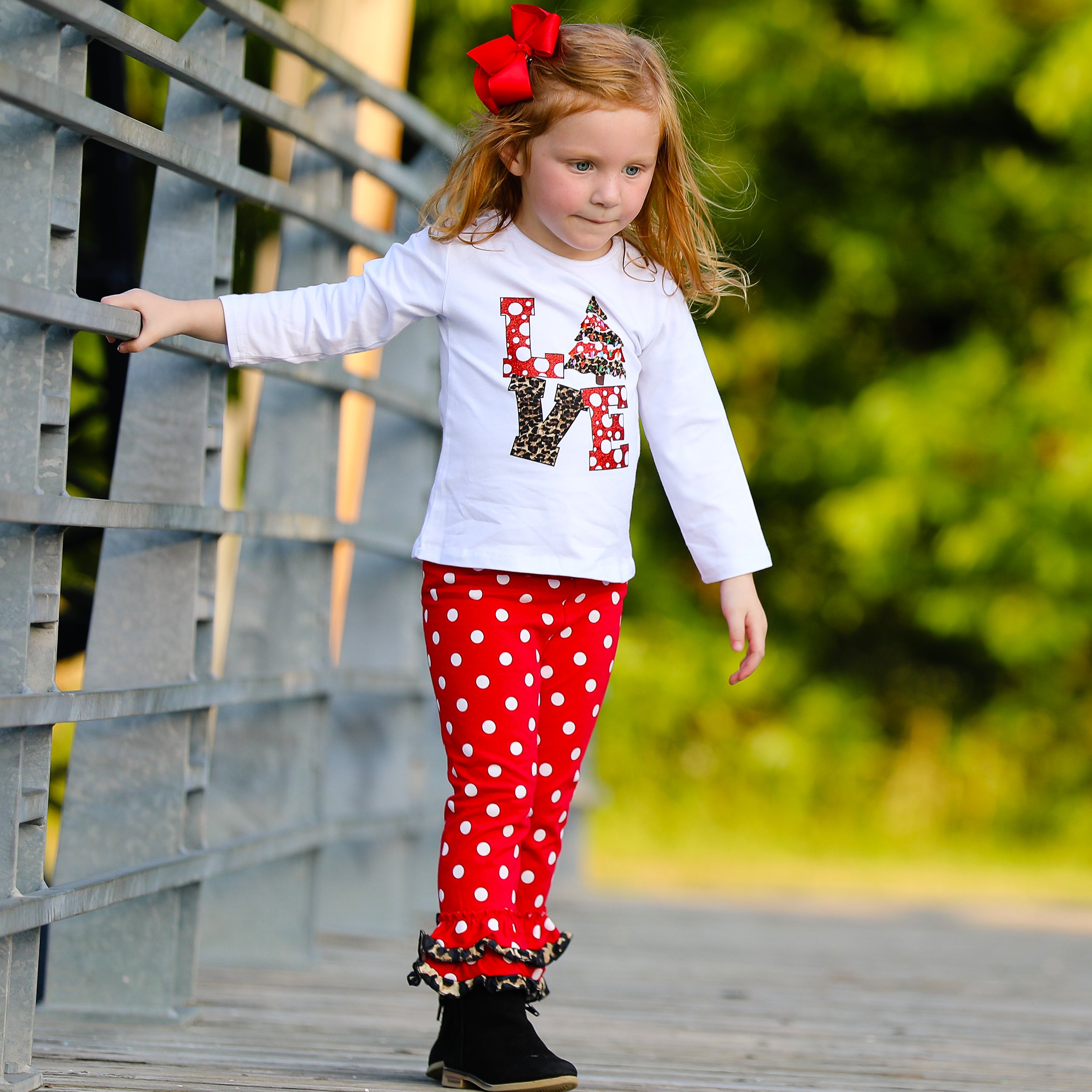Girls LOVE Christmas outfit featuring a top with LOVE applique and red polka dot ruffle pants, perfect for festive occasions.