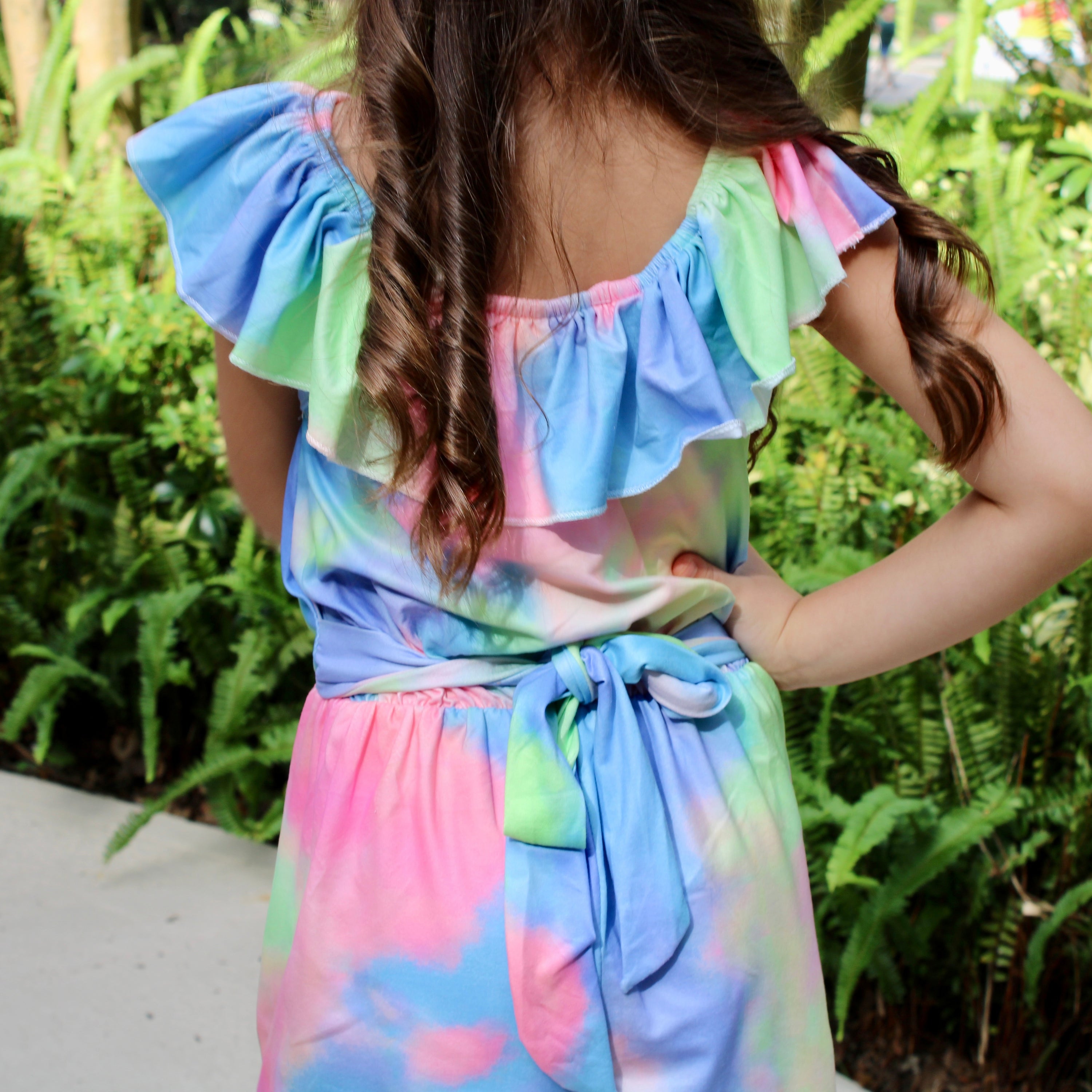 Girls pastel tie dye shorts jumpsuit with ruffle neckline and tie sash, perfect for spring and Easter.