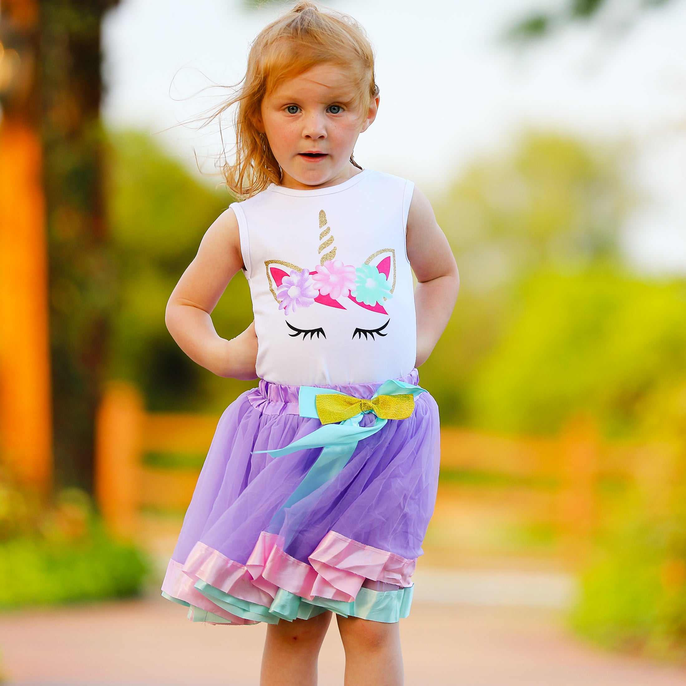 Girls Unicorn Tank Top featuring a silk screen unicorn design paired with a purple tulle skirt with pink satin trim and blue satin bow.