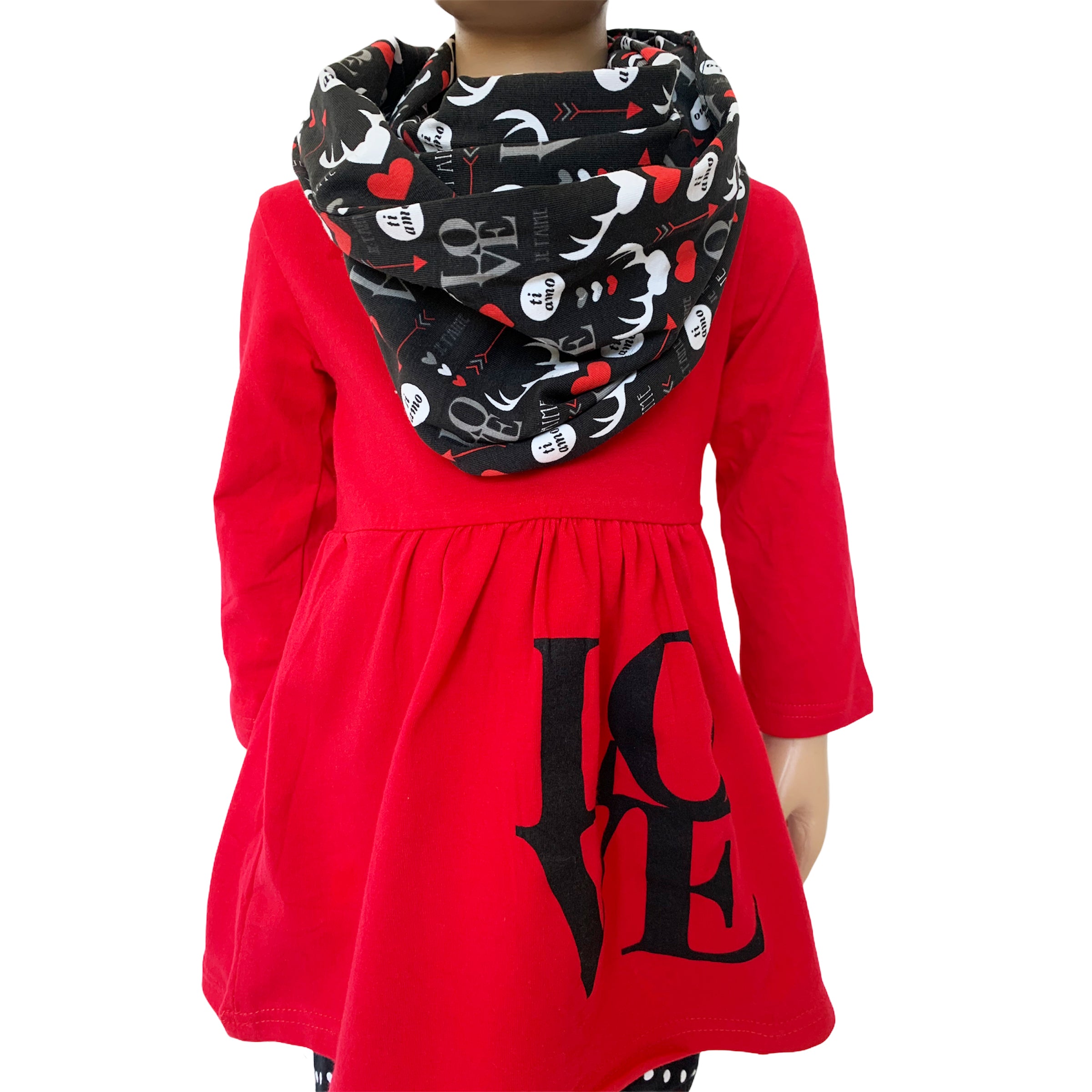 Girls Valentine's Day outfit featuring a red long sleeve tunic with LOVE applique, whimsical black leggings, and a coordinating scarf.