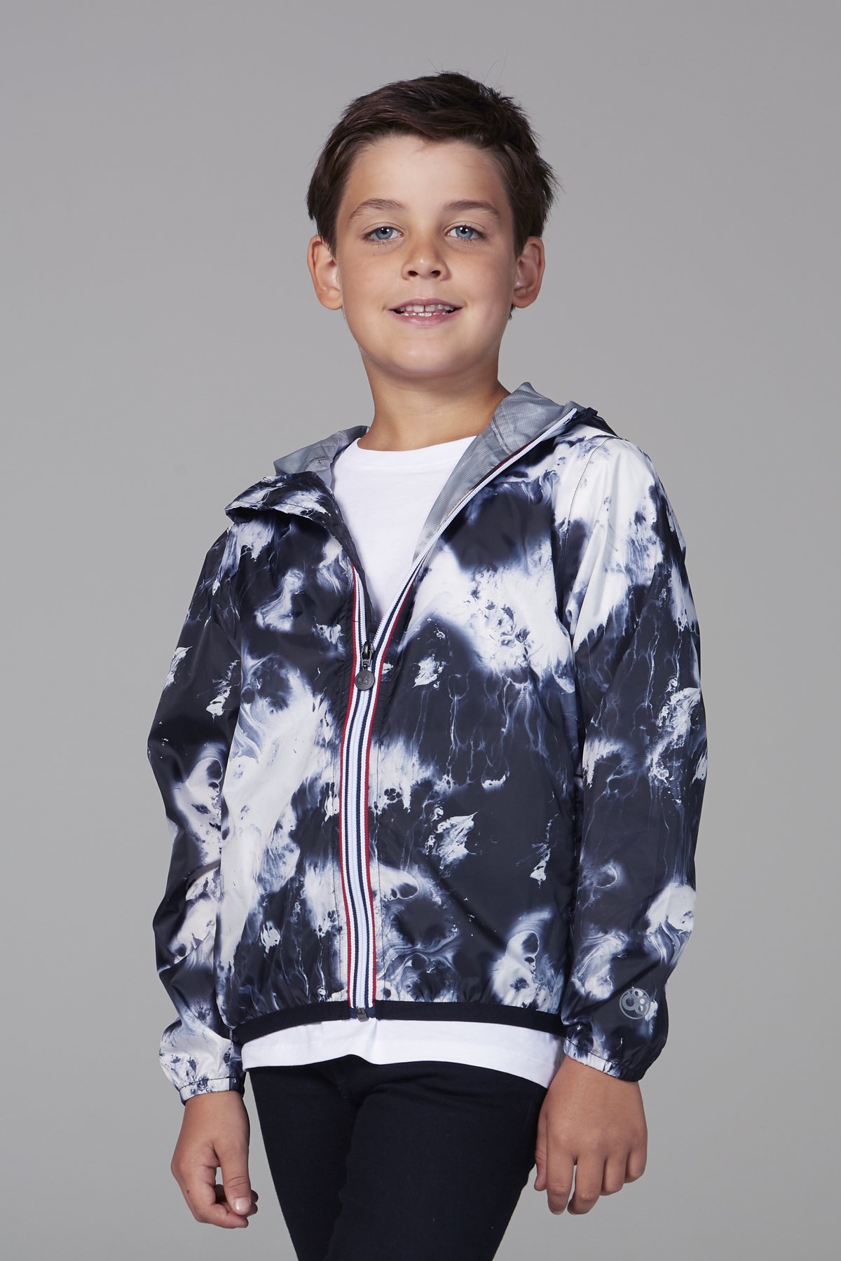 Kids oil print packable rain jacket in vibrant colors, showcasing its waterproof material and packable design.