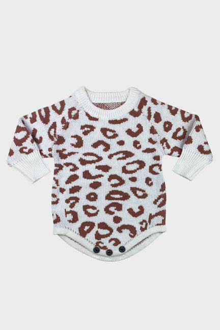 Cozy leopard print knitted onesie in white and pink with brown spots, featuring wooden button closure for easy diaper changes.