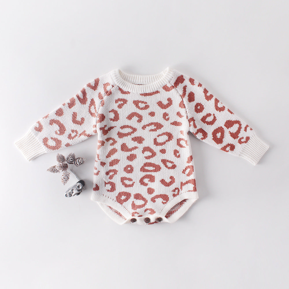 Cozy leopard print knitted onesie in white and pink with brown spots, featuring wooden button closure for easy diaper changes.