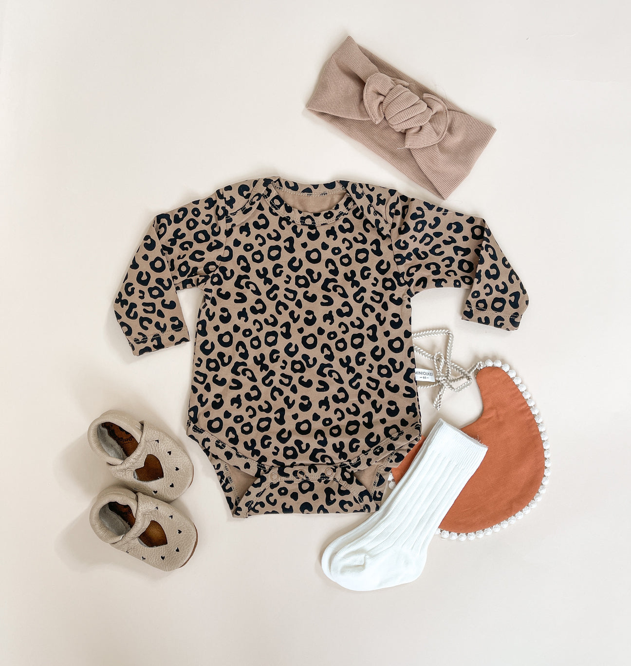 A stylish leopard print romper made from soft cotton, featuring a comfortable fit and trendy design, perfect for casual outings.