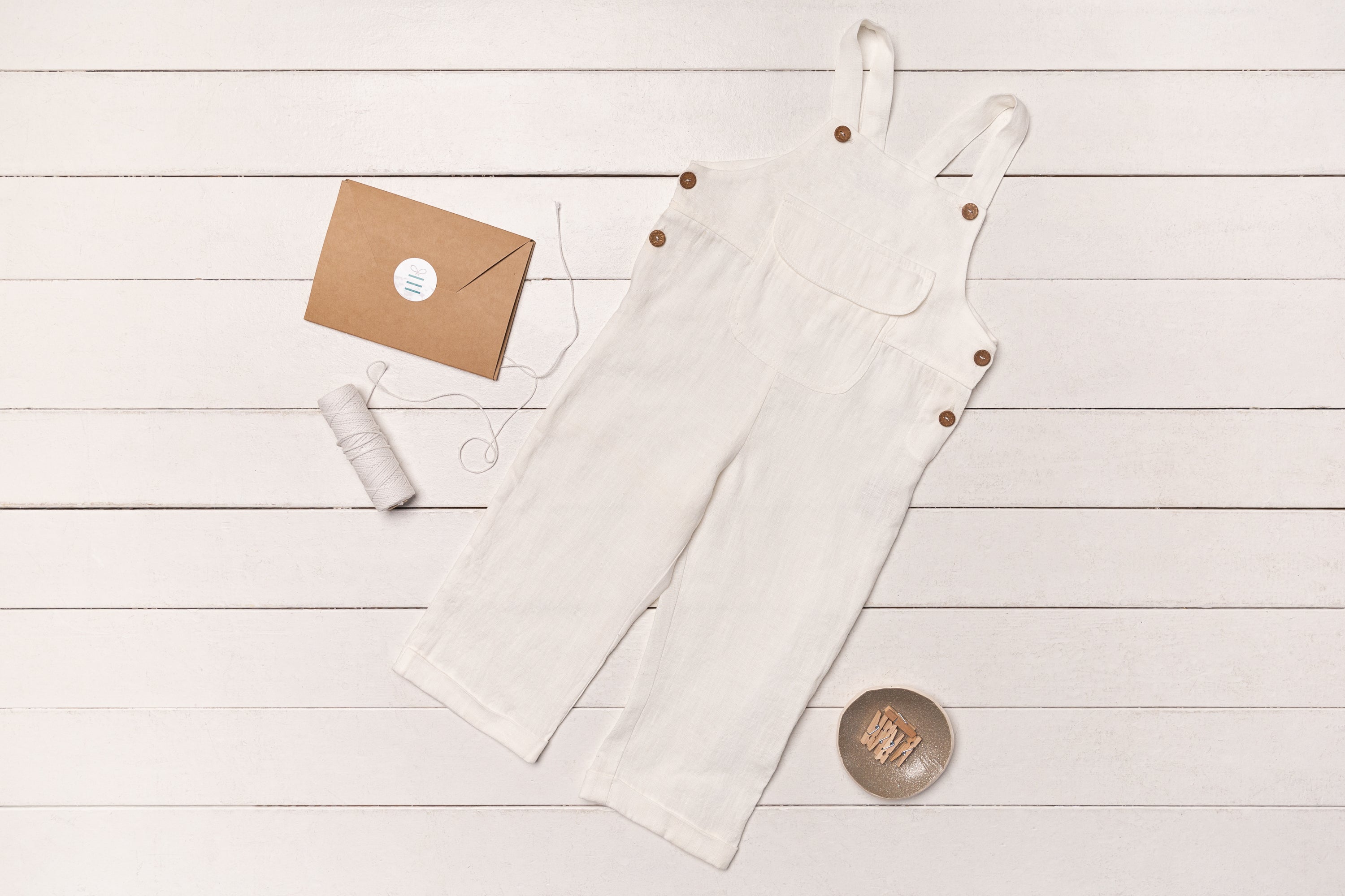 A stylish Linen Jumpsuit for Kids made from 100% European linen, featuring coconut buttons and available in various colors.