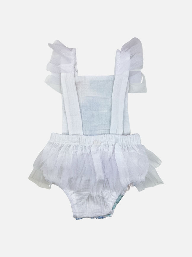 Louella embroidered romper featuring white floral design with tulle ruffles and snap closure.
