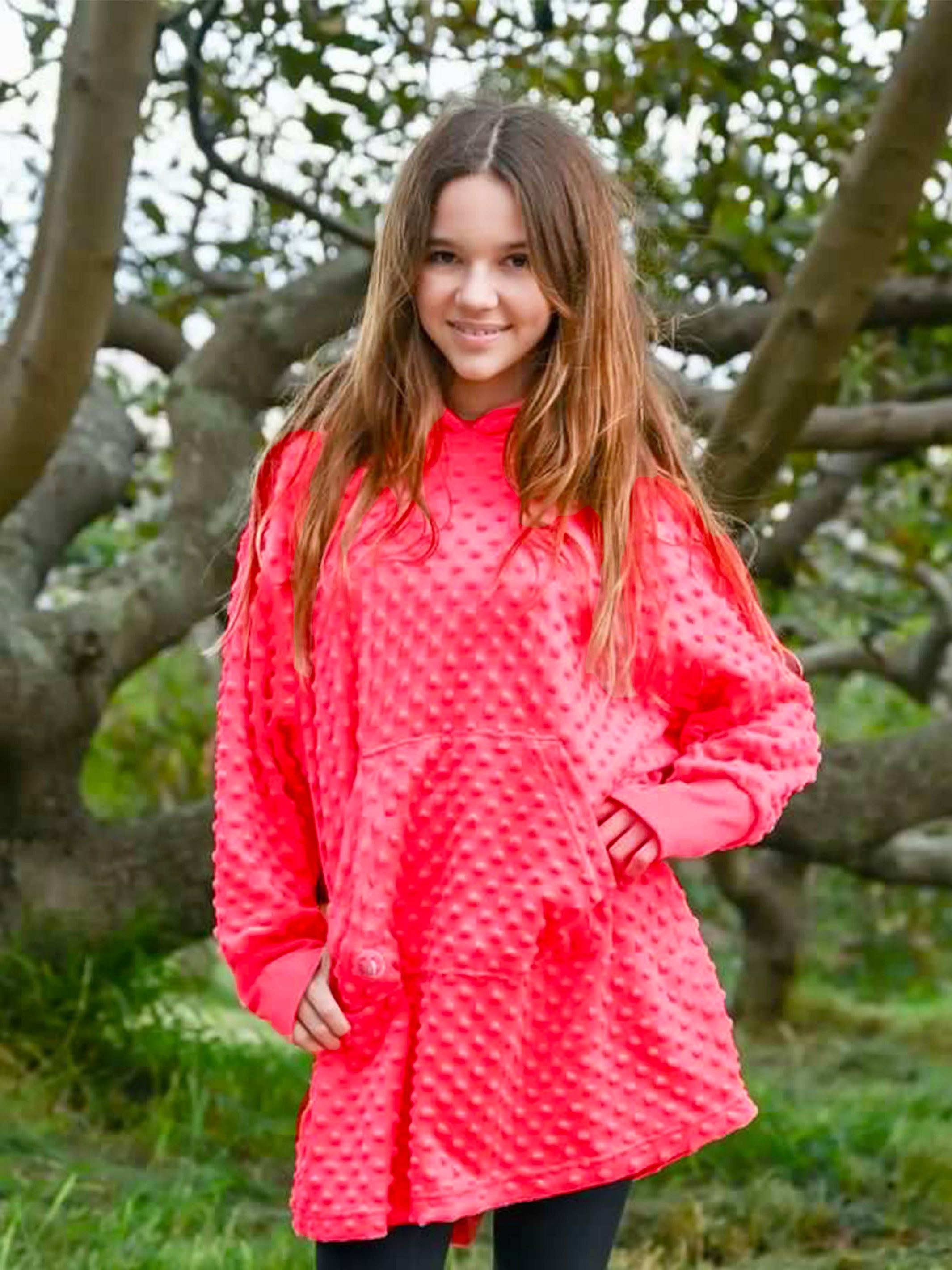 Oversized girls hoodie in Sugar Coral color, featuring plush Minky fabric, oversized sleeves, and a large front pocket.