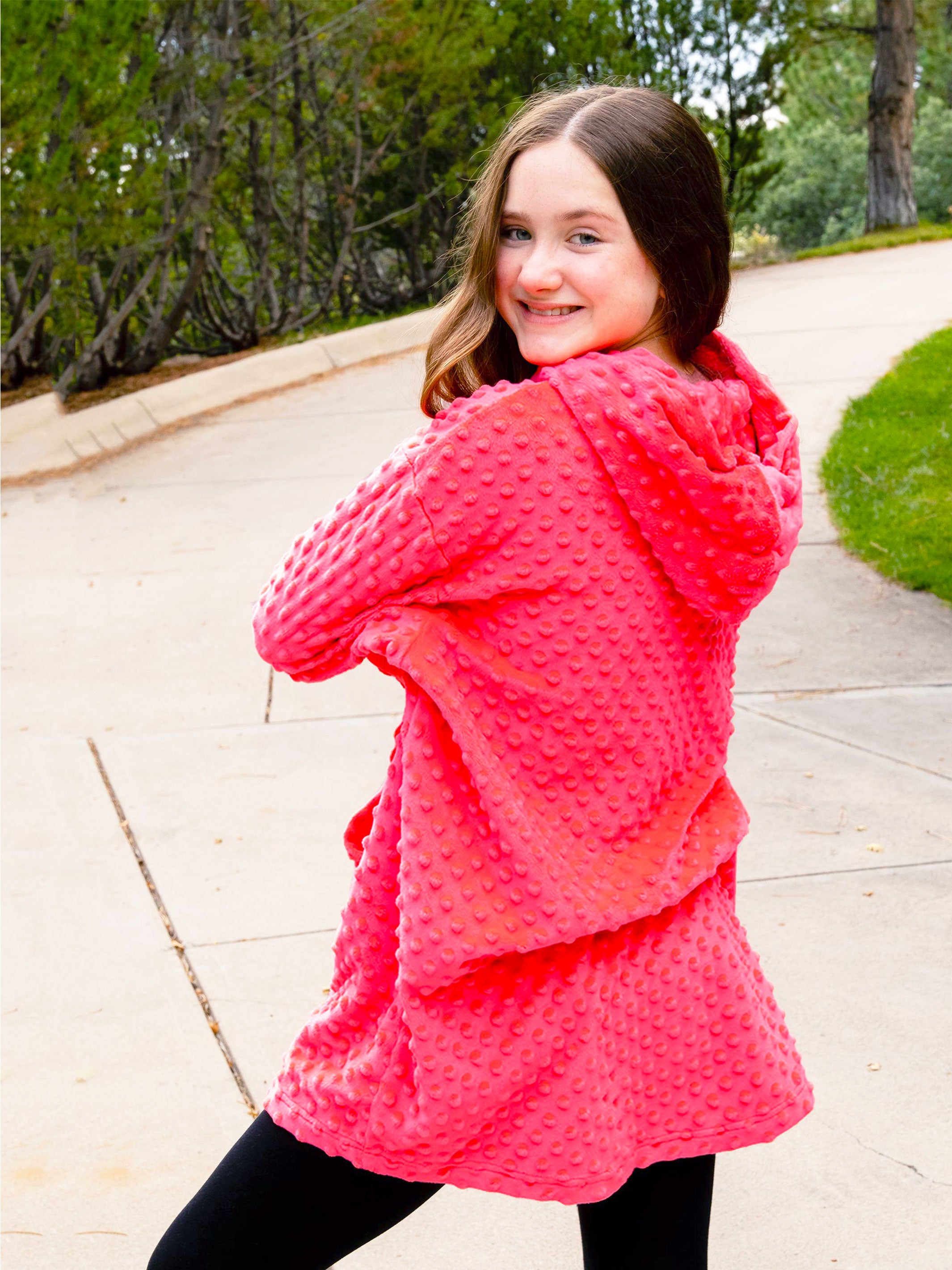 Oversized girls hoodie in Sugar Coral color, featuring plush Minky fabric, oversized sleeves, and a large front pocket.