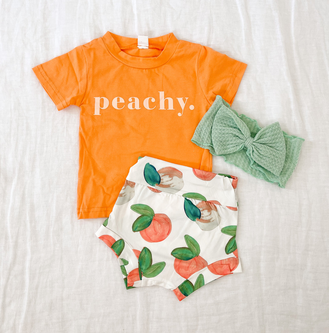 A stylish peach outfit set made of cotton and spandex, featuring a comfortable fit and trendy design.