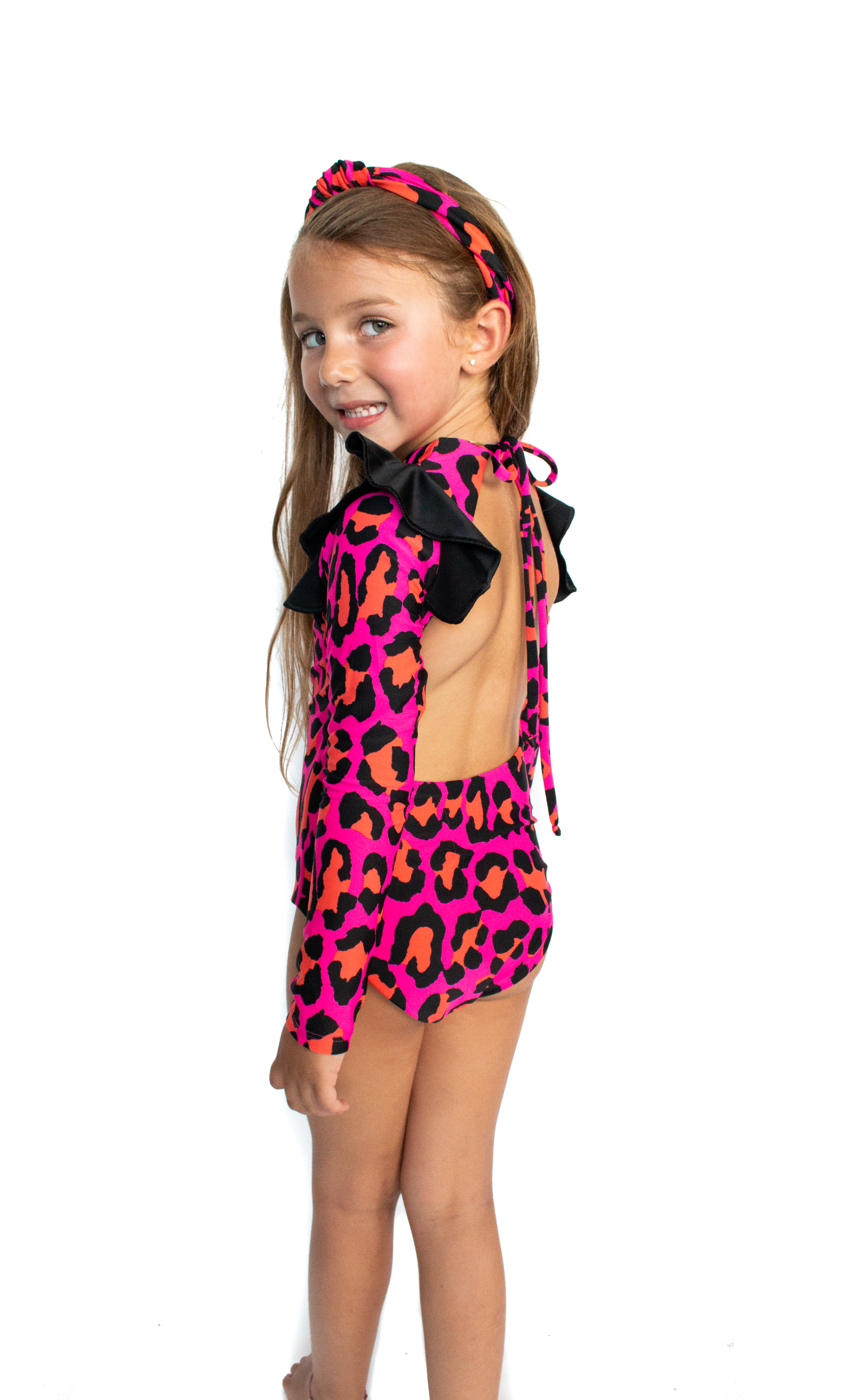 A vibrant pink one piece swimsuit for kids featuring a playful animal print design, perfect for summer swimwear.
