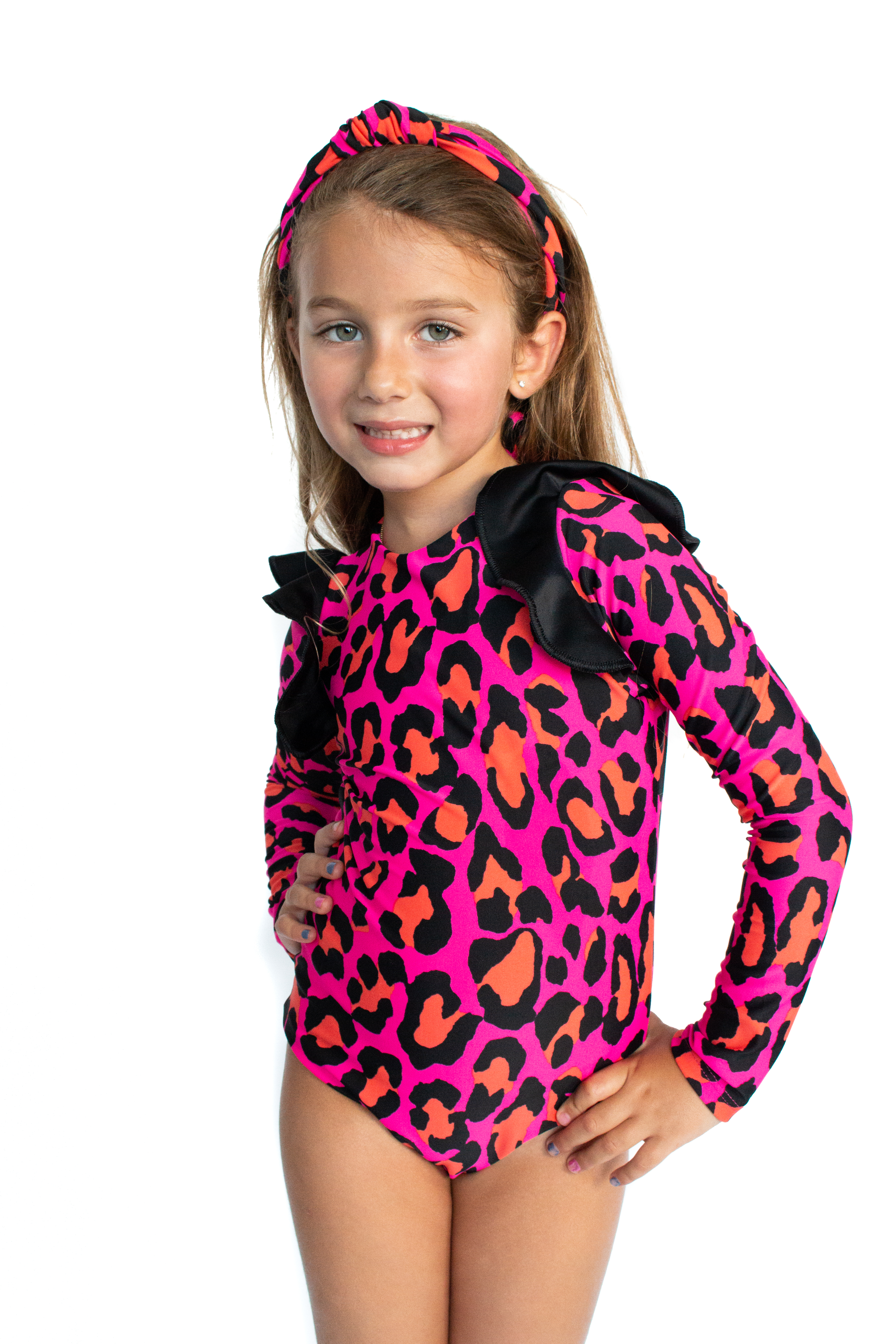 A vibrant pink one piece swimsuit for kids featuring a playful animal print design, perfect for summer swimwear.