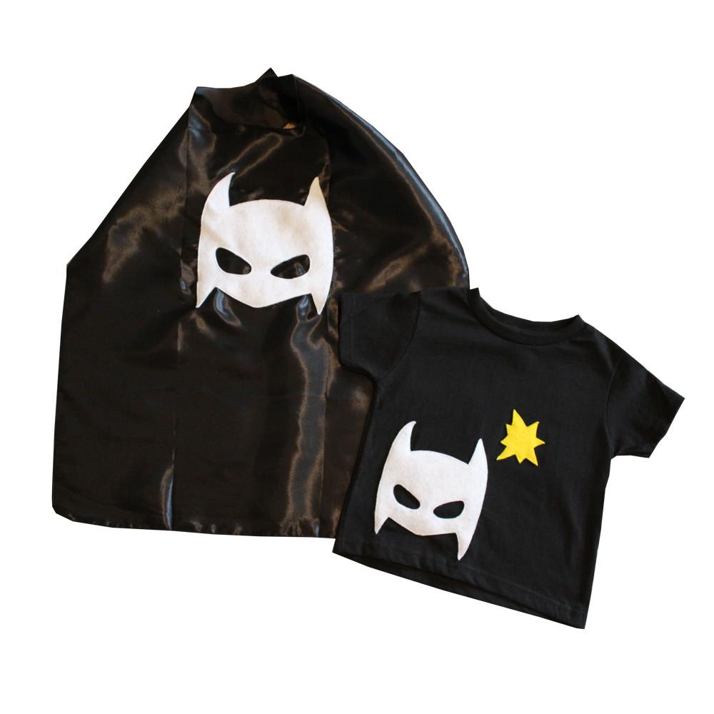 A black superhero tee with colorful felt appliqués and a matching cape, designed for children to unleash their imagination.