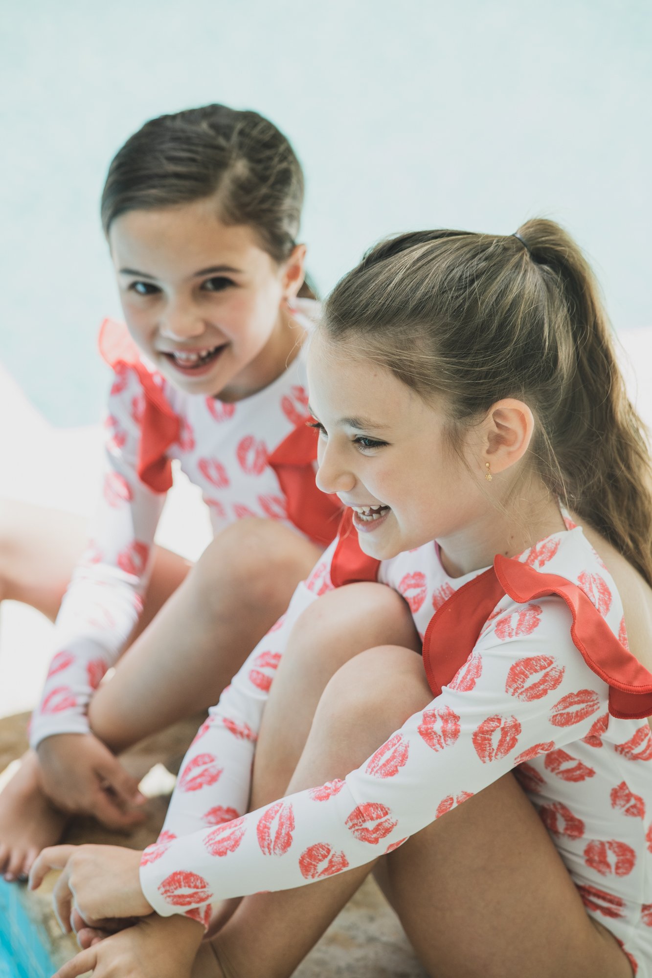 Red Kisses One Piece Kids Swimwear featuring vibrant print and UV protection, perfect for beach and pool activities.