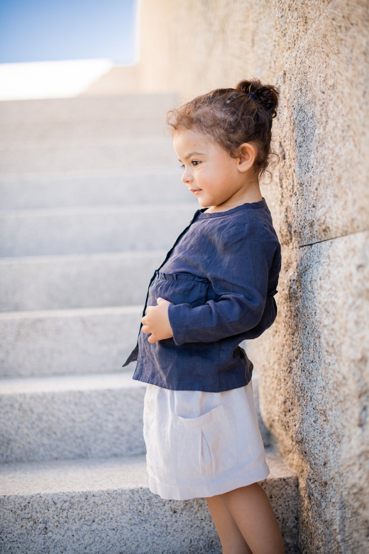 Casual long-sleeved blue linen shirt with frills and olive wood buttons.