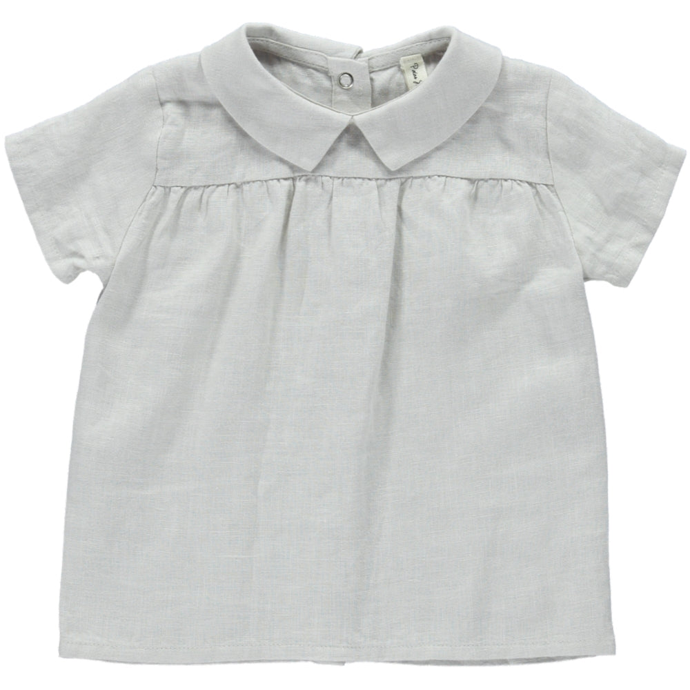 A stylish cream casual shirt made of 100% linen, featuring short sleeves, a round collar, and a snaps closure on the back.